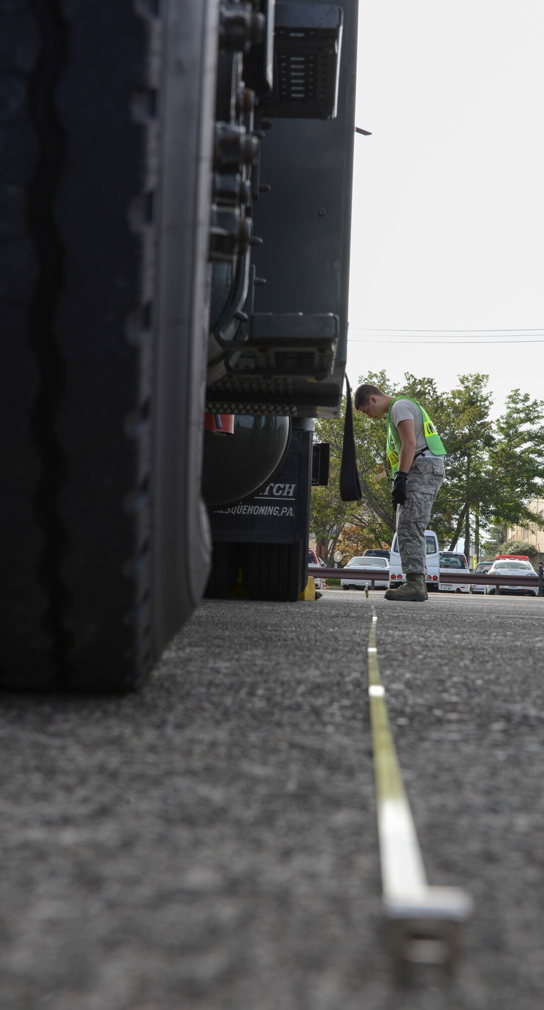 An Airman checks the length of a gasoline truck during a simulated deployment preparation at Yokota Air Base, Japan, Oct. 7, 2013. Every pallet of cargo that was brought out to the flightline had to be weighed and dimensions needed to be measured. (U.S. Air Force photo by Senior Airman Michael Washburn/Released)