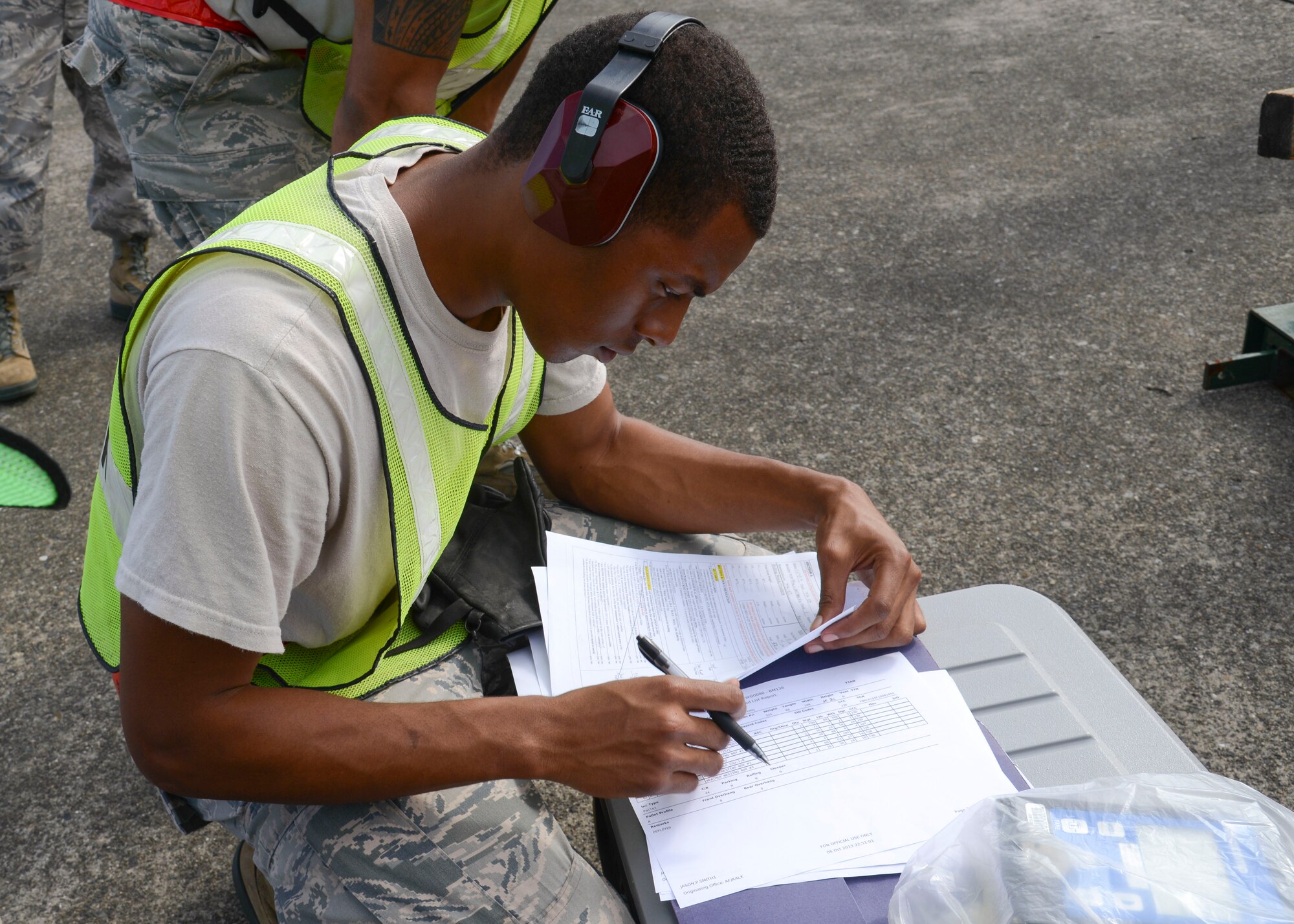 Airman 1st Class Darrell Kennedy, a central storage apprentice with the 374th Logistics Readiness Squadron, checks and documents the weight of cargo at Yokota Air Base, Japan, Oct. 7, 2013.  Members of Yokota participated in a simulated deployment preparation by transporting, measuring and weighing several cargos.  (U.S. Air Force photo by Airman 1st Class Soo C. Kim/released)
