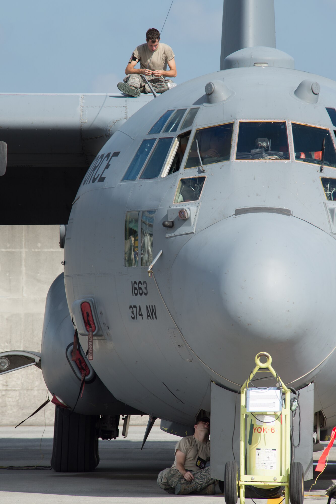 Crew Chiefs from the 374th Aircraft Maintenance Squadron maintain a C-130 Hercules at Yokota Air Base, Japan, Oct. 7, 2013. Airmen are performing a number of exercise tasks as Yokota conducts a Readiness Week. (U.S. Air Force photo by Osakabe Yasuo/Released)