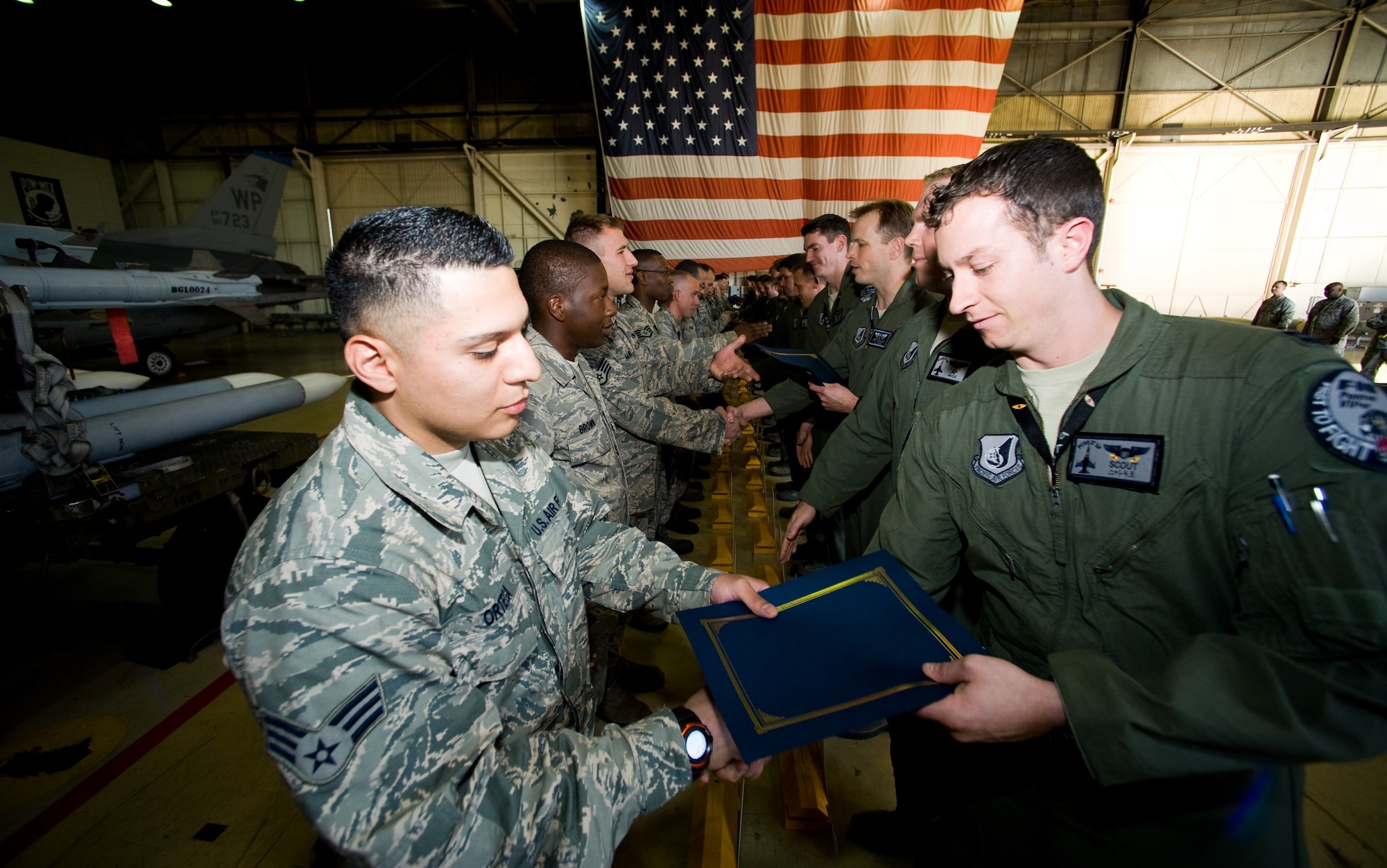 Pilots from the 35th Fighter Squadron present certificates to their dedicated crew chiefs during a ceremony at Kunsan Air Base, Republic of Korea, Oct. 4, 2013. Forty-four maintainers were entrusted with F-16 Fighting Falcons during the 2013 Dedicated Crew Chief Ceremony. All 44 Airmen voluntarily took responsibility of their aircraft.  A dedicated crew chief is the last to see the pilot go, the first to receive them and ensures the aircraft is prepared to complete its mission.  (U.S. Air Force photo by Senior Airman Armando A. Schwier-Morales/Released)