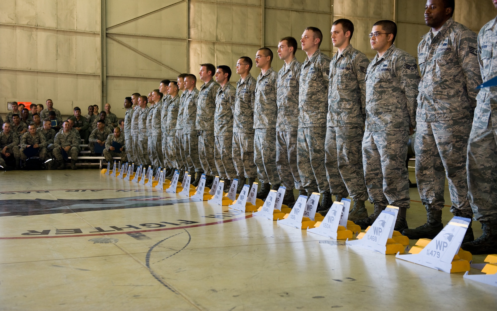 Crew chiefs from the 8th Aircraft Maintenance Squadron line up to be recognized by their pilot during the 2013 Dedicated Crew Chief Ceremony at Kunsan Air Base Republic of Korea, Oct. 4, 2013. F-16 Fighting Falcons assigned to the 8th Fighter Wing are given a dedicated crew chief to ensure the aircrafts ability to complete its mission. Forty-four maintainers were entrusted with F-16s during the ceremony. (U.S. Air Force photo by Senior Airman Armando A. Schwier-Morales/Released)