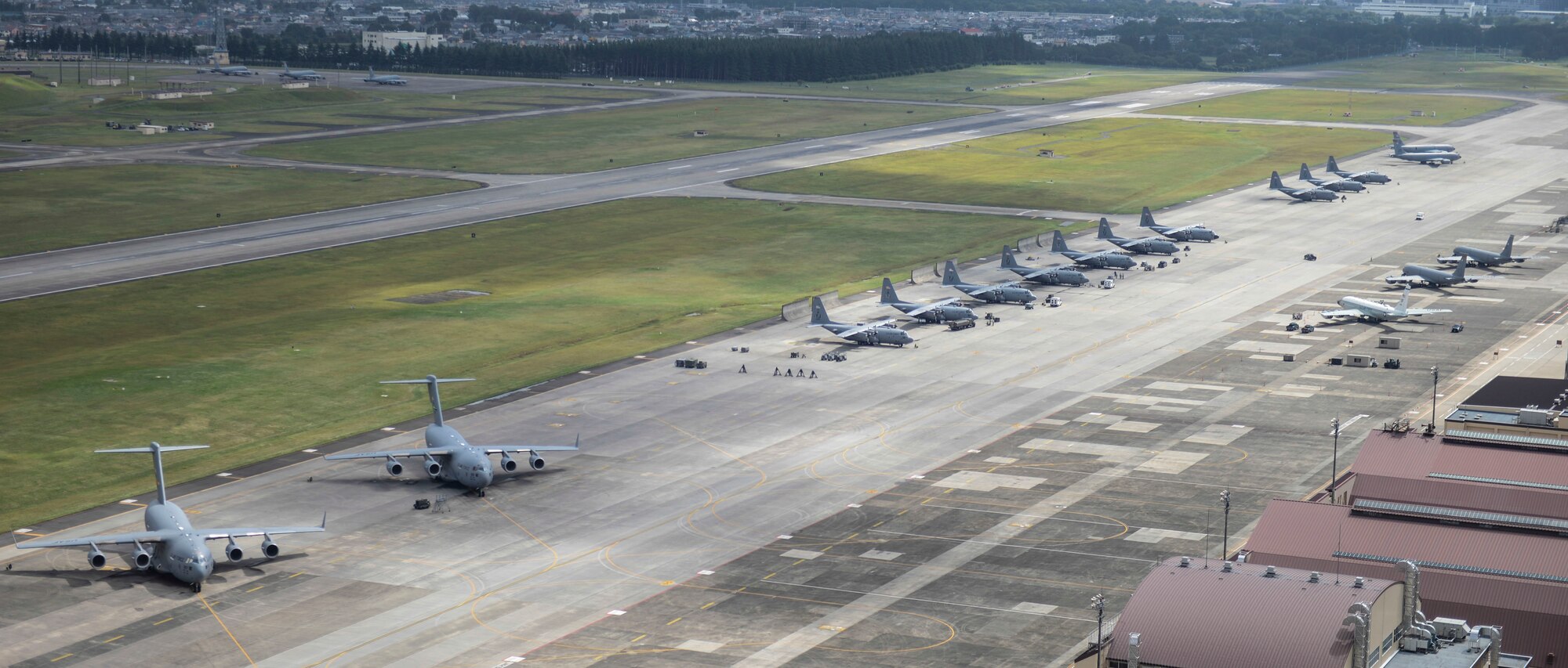 Aircraft fill the taxiway at Yokota Air Base, Japan, Oct. 7, 2013. 18 aircraft from Kadena Air Base and Marine Corps Air Station Futenma diverted to Yokota due to the impact of two typhoons. (U.S. Air Force photo by Airman 1st Class Meagan Schutter)