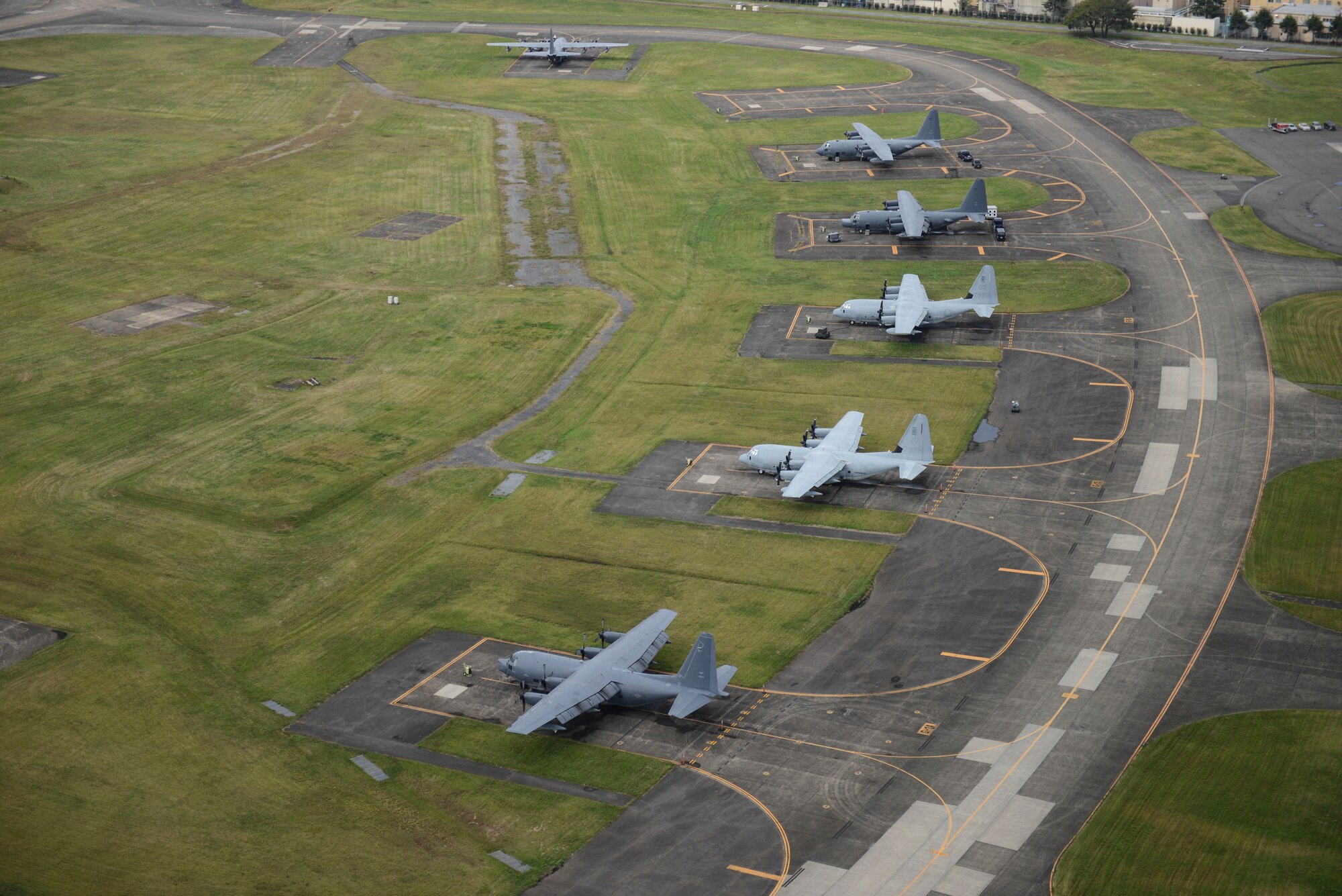MC-130P Combat Shadow and KC-130J Marine Super Hercules aircraft park at Yokota Air Base, Japan, Oct. 7, 2013. 18 aircraft from Kadena Air Base and Marine Corps Air Station Futenma diverted to Yokota due to the impact of two typhoons. (U.S. Air Force photo by Airman 1st Class Meagan Schutter)
