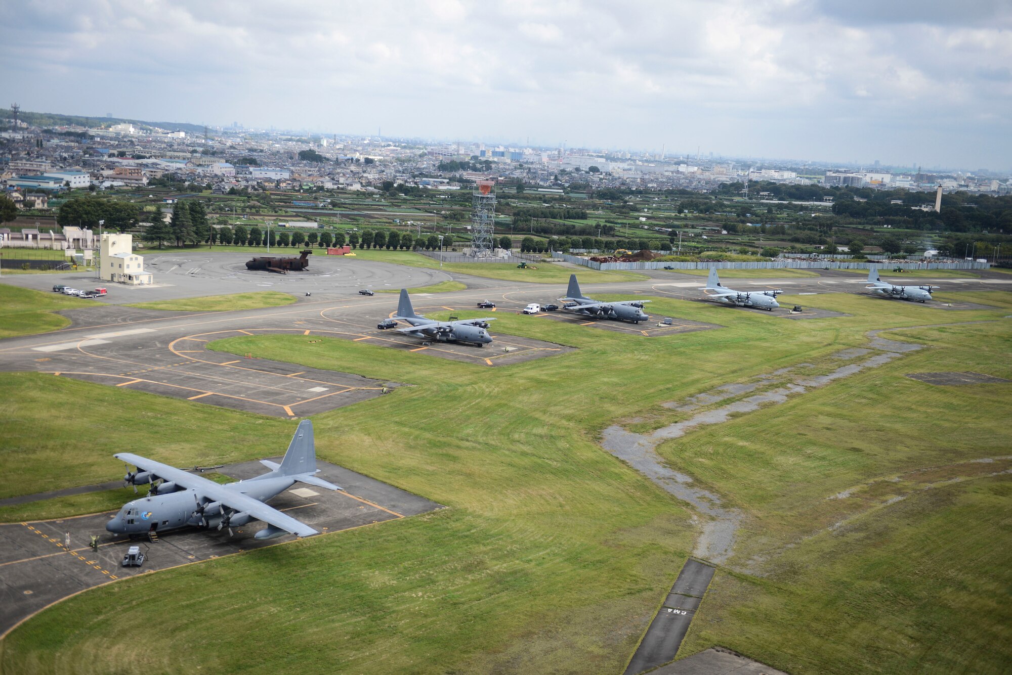 MC-130P Combat Shadow and KC-130J Marine Super Hercules aircraft park at Yokota Air Base, Japan, Oct. 7, 2013. 18 aircraft from Kadena Air Base and Marine Corps Air Station Futenma diverted to Yokota due to the impact of two typhoons. (U.S. Air Force photo by Airman 1st Class Meagan Schutter)