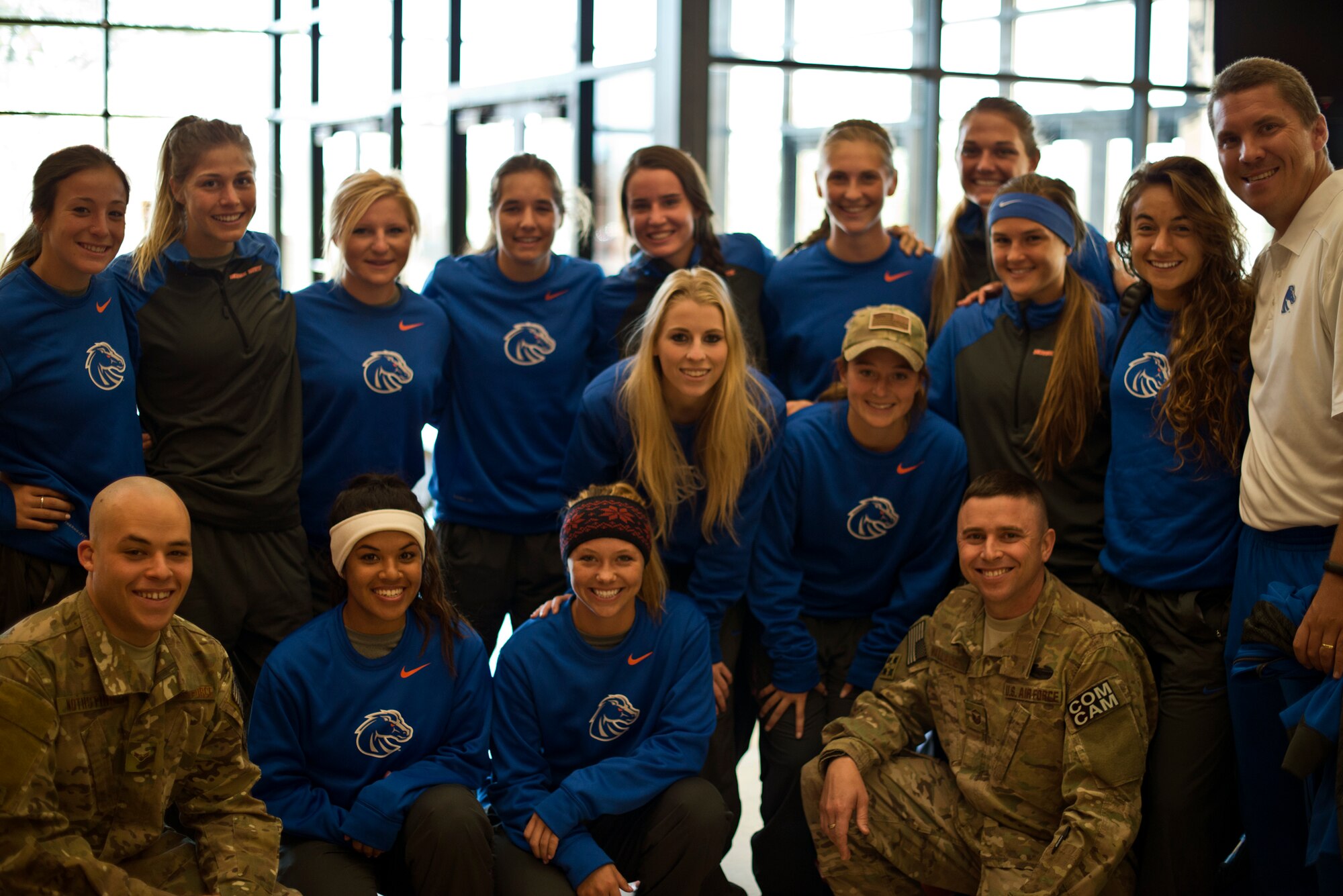 The Boise State University ladies soccer team and Ed Moore, Broncos assistant coach (white shirt) met with Air Force Master Sgt. Kevin Wallace (front-right) and Airman 1st Class Devin Nothstine at Mountain Home Air Force Base, Idaho, Oct. 5, 2013. Wallace recounted combat experiences for the Broncos, then the team hosted a soccer clinic for base families, all in support of their upcoming Military Appreciation Day. (U.S. Air Force photo by Senior Airman Jaye Legate/RELEASED)