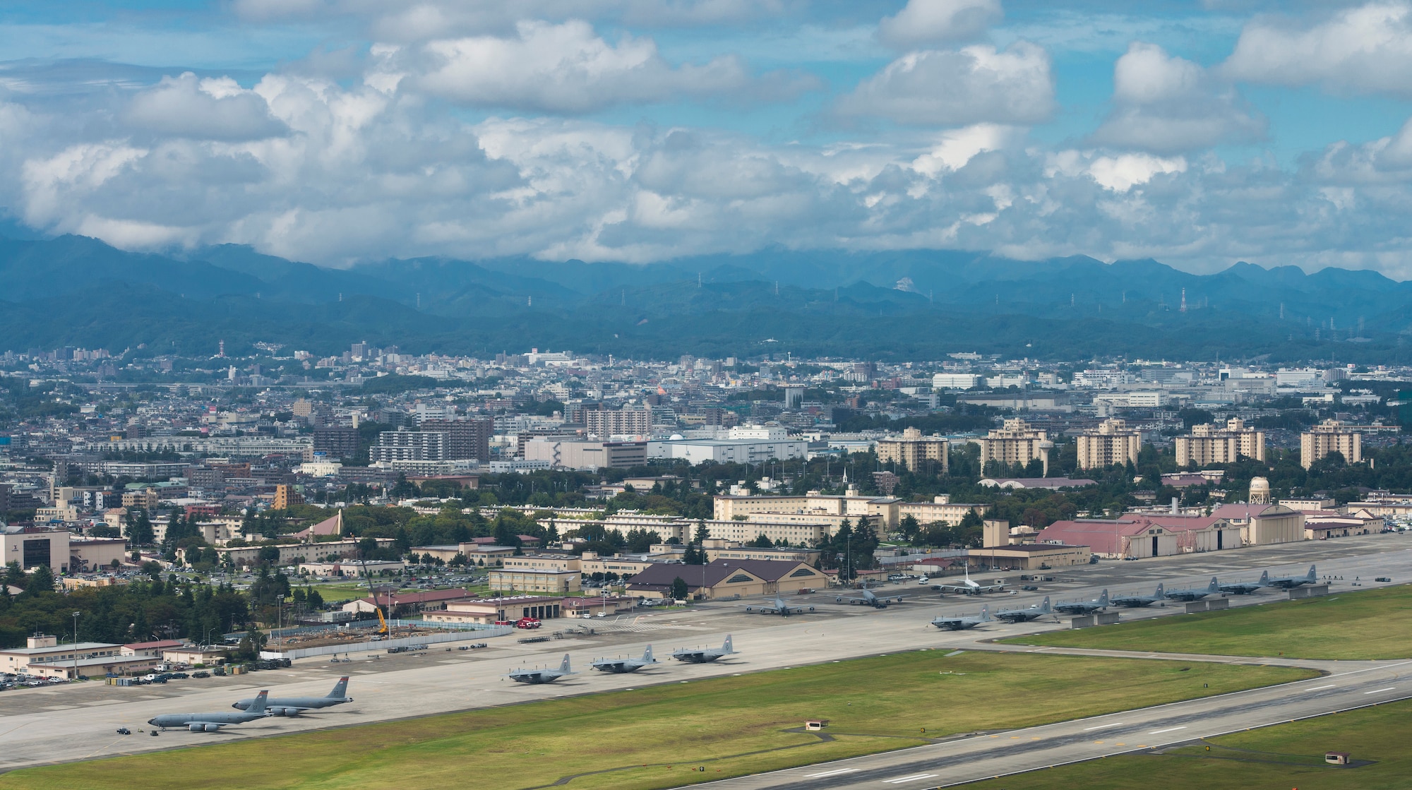 Aircraft fill the taxiway at Yokota Air Base, Japan, Oct. 7, 2013. 18 aircraft from Kadena Air Base and Marine Corps Air Station Futenma diverted to Yokota due to the impact of two typhoons. (U.S. Air Force photo by Staff Sgt. Chad C. Strohmeyer/Released)