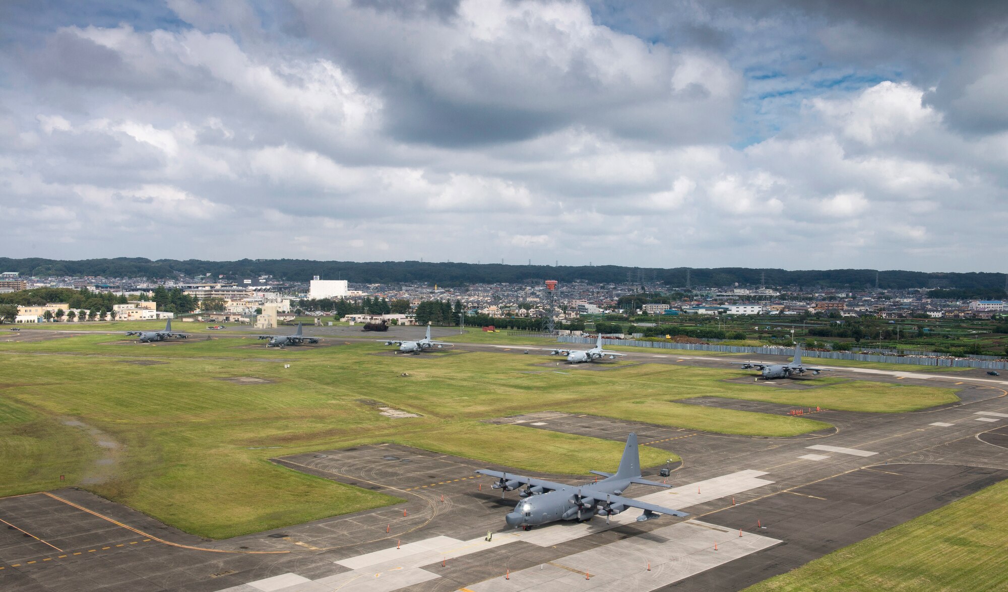 MC-130P Combat Shadow and KC-130J Marine Super Hercules aircraft park at Yokota Air Base, Japan, Oct. 7, 2013. 18 aircraft from Kadena Air Base and Marine Corps Air Station Futenma diverted to Yokota due to the impact of two typhoons. (U.S. Air Force photo by Staff Sgt. Chad C. Strohmeyer/Released)