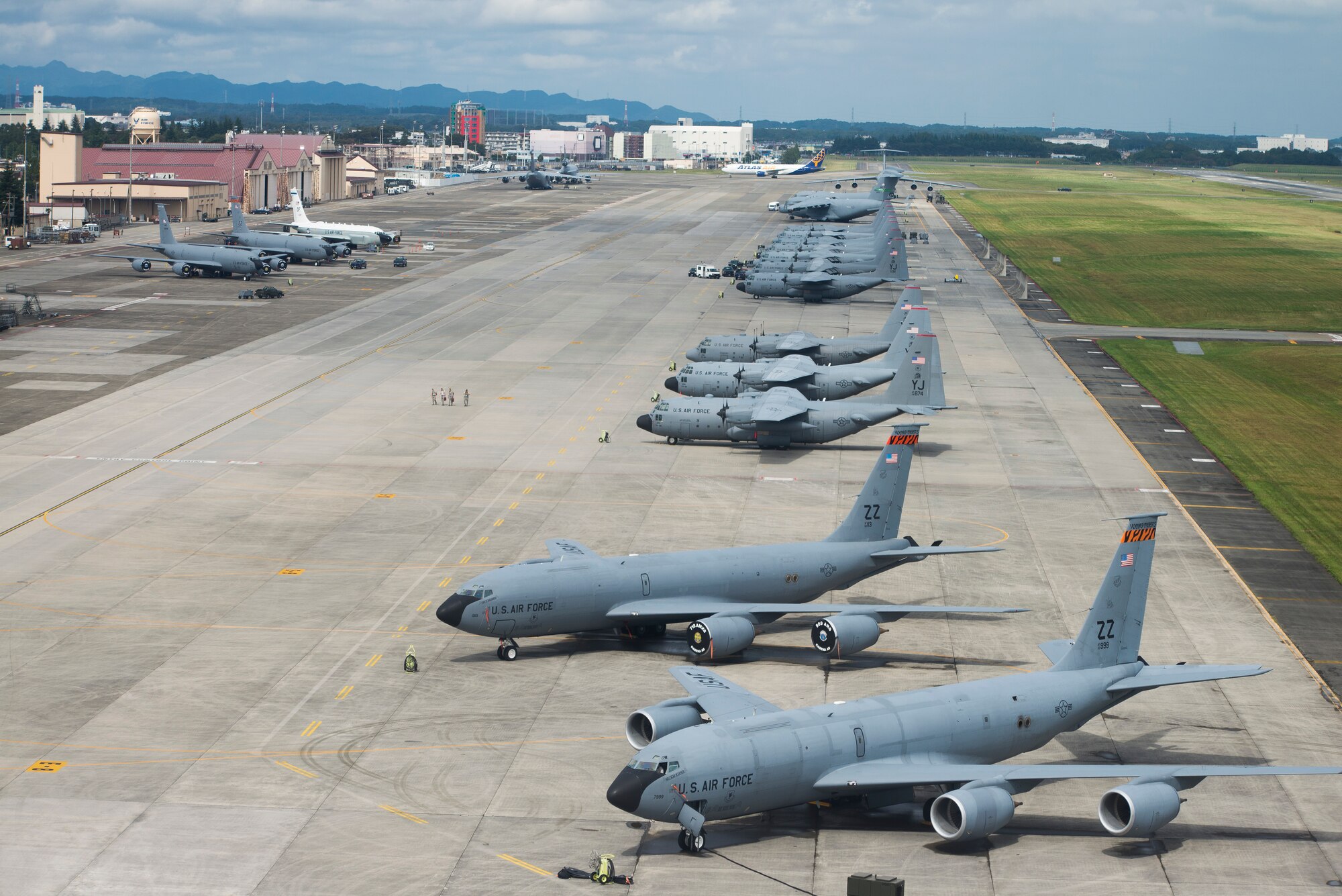 Aircraft fill the taxiway at Yokota Air Base, Japan, Oct. 7, 2013. 18 aircraft from Kadena Air Base and Marine Corps Air Station Futenma diverted to Yokota due to the impact of two typhoons. (U.S. Air Force photo by Staff Sgt. Chad C. Strohmeyer/Released)