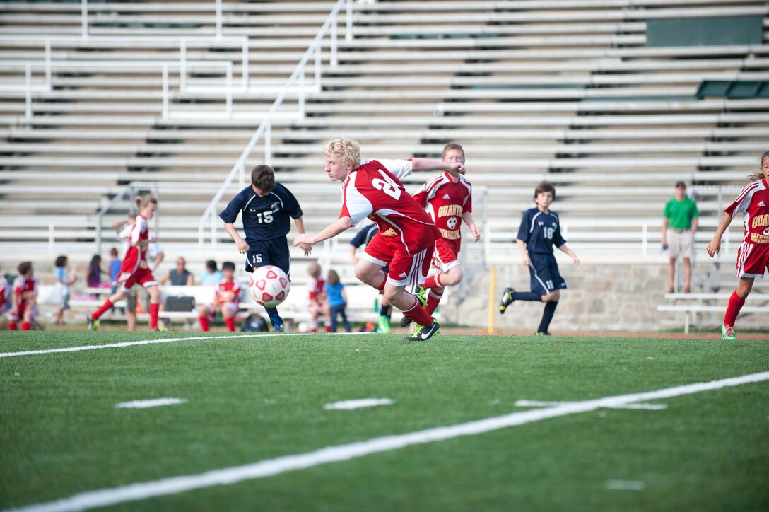 A player from the middle school co-ed soccer team from Quantico Middle/High School prepares to kick a ball during a game against the boy’s middle school soccer team from Fredericksburg Academy at Butler Stadium aboard Marine Corps Base Quantico on Oct. 3, 2013. Quantico tied their game with Fredericksburg Academy 0-0.
