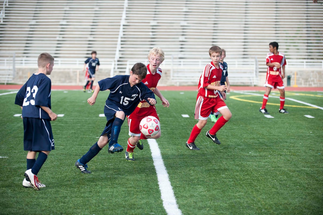 Players from the boy’s middle school soccer team from Fredericksburg Academy kicks the ball during a game against the middle school co-ed soccer team from Quantico Middle/High School at Butler Stadium aboard Marine Corps Base Quantico on Oct. 3. 2013. Quantico tied their game with Fredericksburg Academy.  