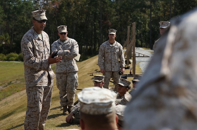 Capt. Thomas Q. Kearns (left), the director of the Battle Skills Training School, 2nd Marine Logistics Group, speaks to a BSTS machine gunner class prior to a live-fire exercise aboard Camp Lejeune, N.C., Oct. 4, 2013. The class received hours of classroom and hands-on instruction with M240B medium machine guns, MK19 Grenade launchers and M2 Browning .50-caliber machine guns to help prepare them for combat environments. 