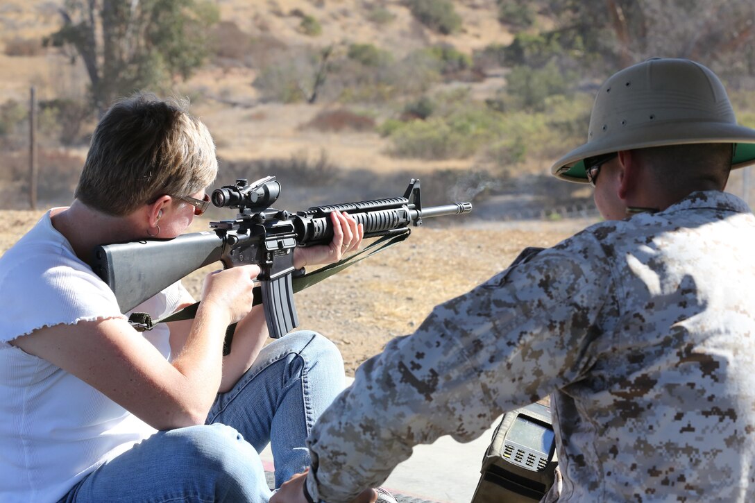 Sandy Breeden, spouse of Col. Chad Breeden, sights in down range and engages targets during a Jane Wayne Live Fire Shoot at the Carlos Hathcock Range aboard Marine Corps Air Station Miramar, Calif., Sept. 28. The spouses shot 3,000 rounds and then conducted a police call after the firing had ceased. 