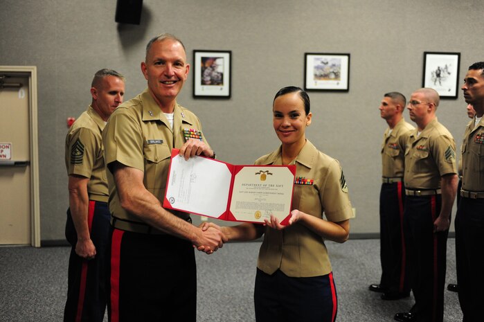 Maj. Gen. Mark Brilakis, commanding general of Marine Corps Recruiting Command presents Sgt. Sonya Bryant with a Navy Achievement Medal in Kansas City, Mo. Oct. 8. Brilakis visited the 9th Marine Corps District as part of his ongoing initial command visits since taking charge of the Marine Corps Recruiting Command.