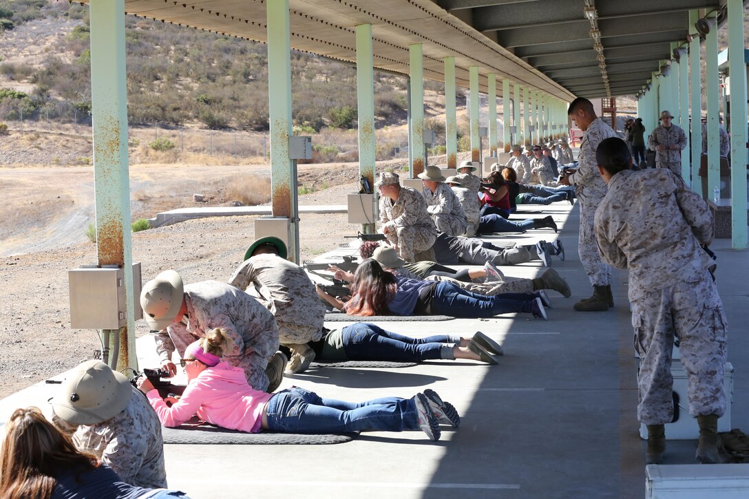 Family members of MWCS-38 take their shooting positions during a Jane Wayne Day Live Fire Shoot at the Carlos Hathcock Range aboard Marine Corps Air Station Miramar, Calif. Sept. 28.  A total of 3,000 rounds were sent down range at the event. 