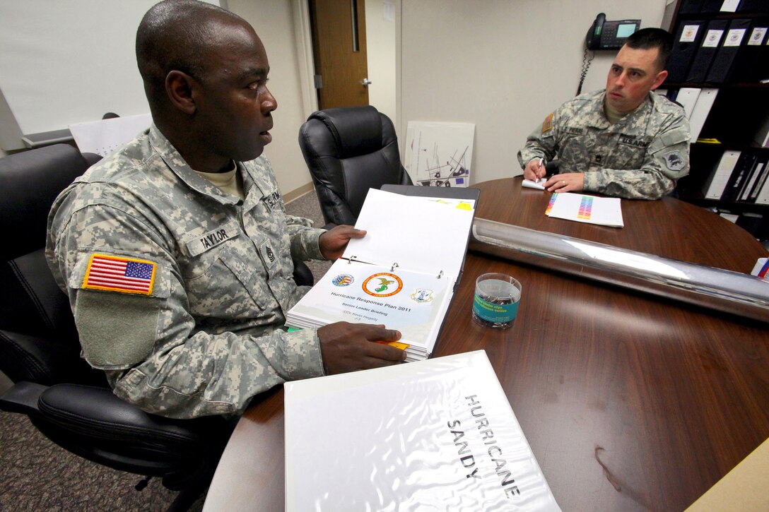 Sgt. Maj. Terrence Taylor, left, and Sgt. 1st Class Richard St. Pierre update hurricane response plans in preparation for Hurricane Sandy at the Homeland Security Center of Excellence in Lawrenceville, N.J., Oct. 26, 2012.
