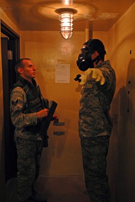 Senior Airman Bryan Horvath, 694th Intelligence Support Squadron mission systems administrator, simulates procedures for the decontamination control area in the Korea Combat Operations Intelligence Center at Osan Air Base, Republic of Korea, Oct. 3, 2013. Airmen in the 694th Intelligence Surveillance and Reconnaissance Group participated in the 24-hour lock-in training event to sharpen their wartime operations skills. (U.S. Air Force photo/1st Lt. Kay M. Nissen)