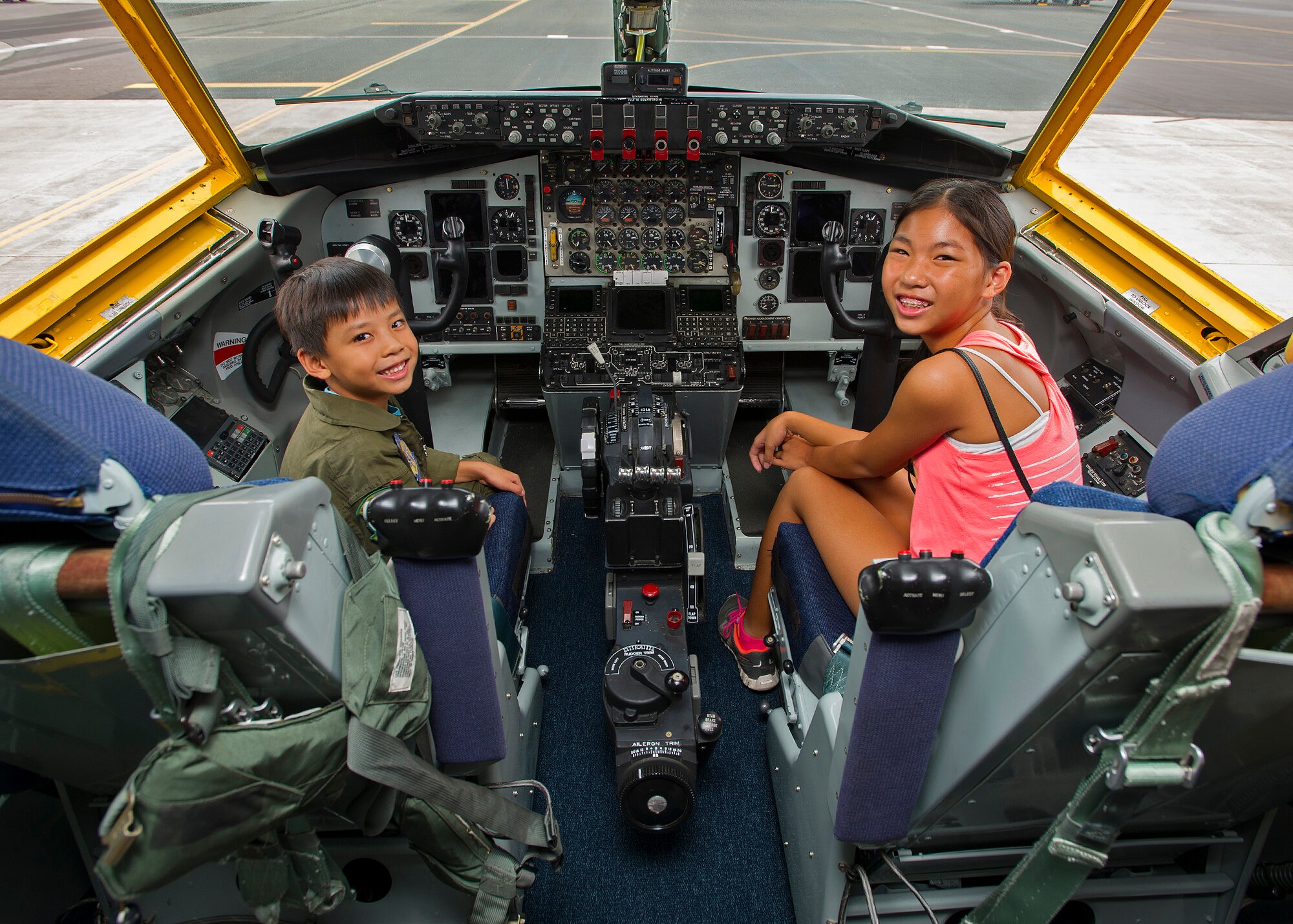 Kodey Deuz, a child battling aortic stenosis, aortic insufficiency and mitral regurgitation, left, and his sister Kelci, right, pose for a photo from the cockpit of a KC-135 Stratotanker on the flightline at Joint Base Pearl Harbor-Hickam, Hawaii, Oct. 4, 2013. Kodey was part of the 96th Airlift Squadron Pilot for a Day program, which allows children with catastrophic disorders or illnesses to experience a day in the life of an Air Force pilot. (U.S. Air Force photo/Tech. Sgt. Jerome S. Tayborn)