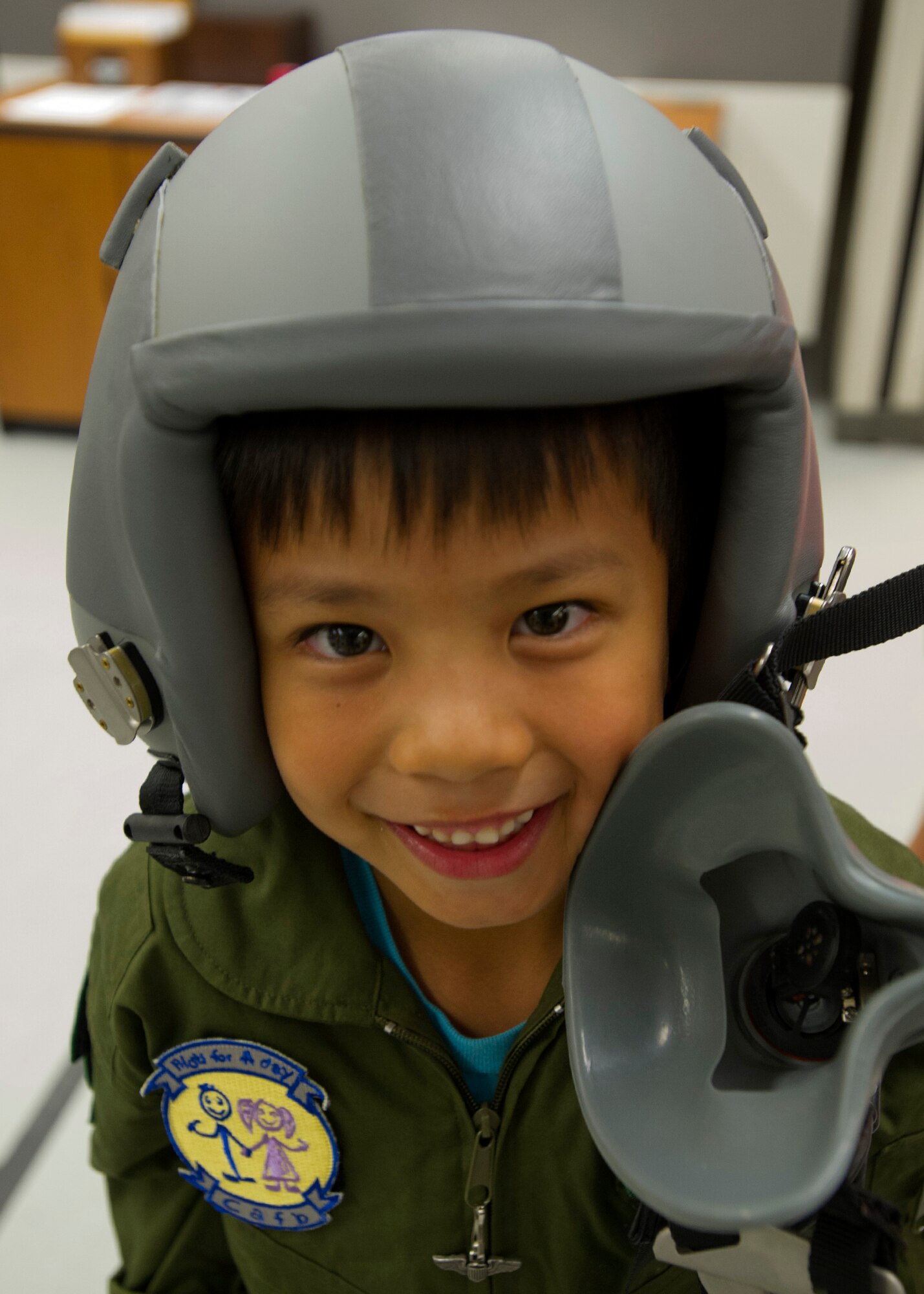 Kodey Deuz (right), a child battling, aortic stenosis, aortic insufficiency and mitral regurgitation, poses for a portrait as part of the Pilot for a Day program at Joint Base Pearl Harbor-Hickam, Hawaii, Oct. 4, 2013. The original "Pilot for a Day" program began in December of 1994, organized by Captain Rory "Ox" Blackburn at Randolph Air Force Base, Texas. (U.S. Air Force photo/Tech. Sgt. Jerome S. Tayborn)
