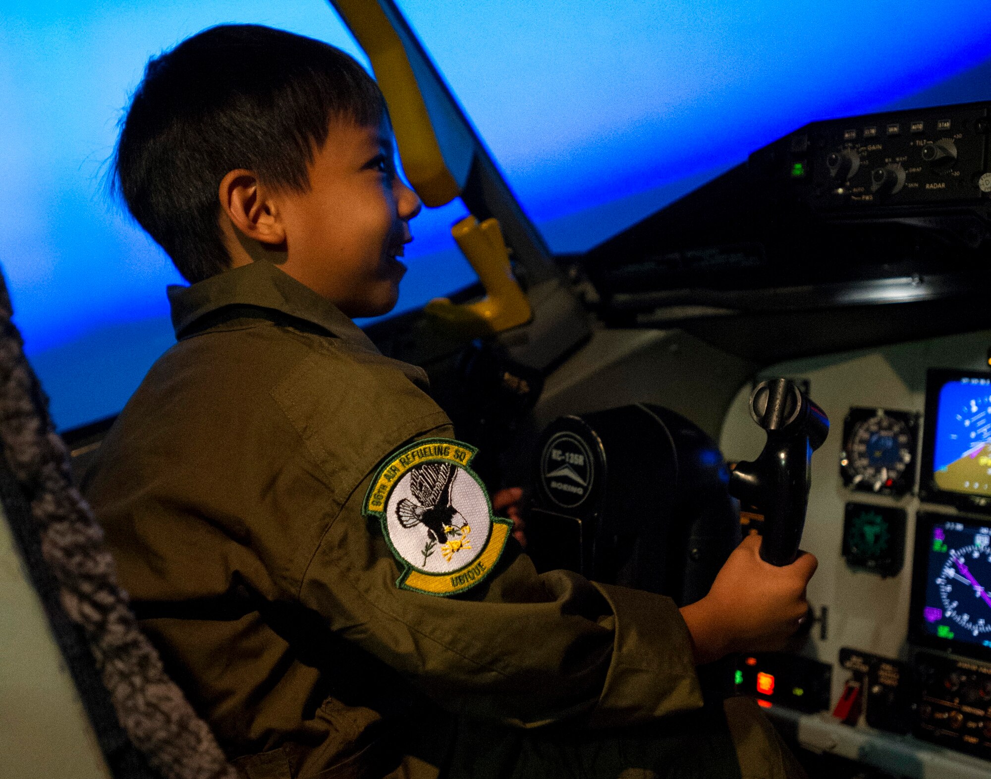 Kodey Deuz, a child battling aortic stenosis, aortic insufficiency and mitral regurgitation, sits in the pilot seat of the KC-135 aircraft simulator as part of the Pilot for a Day program at Joint Base Pearl Harbor-Hickam, Hawaii, Oct. 4, 2013. Aortic stenosis, aortic insufficiency and mitral regurgitation are all heart valve defects which cause issues with blood flow and leakage.  (U.S. Air Force photo/Tech. Sgt. Jerome S. Tayborn)