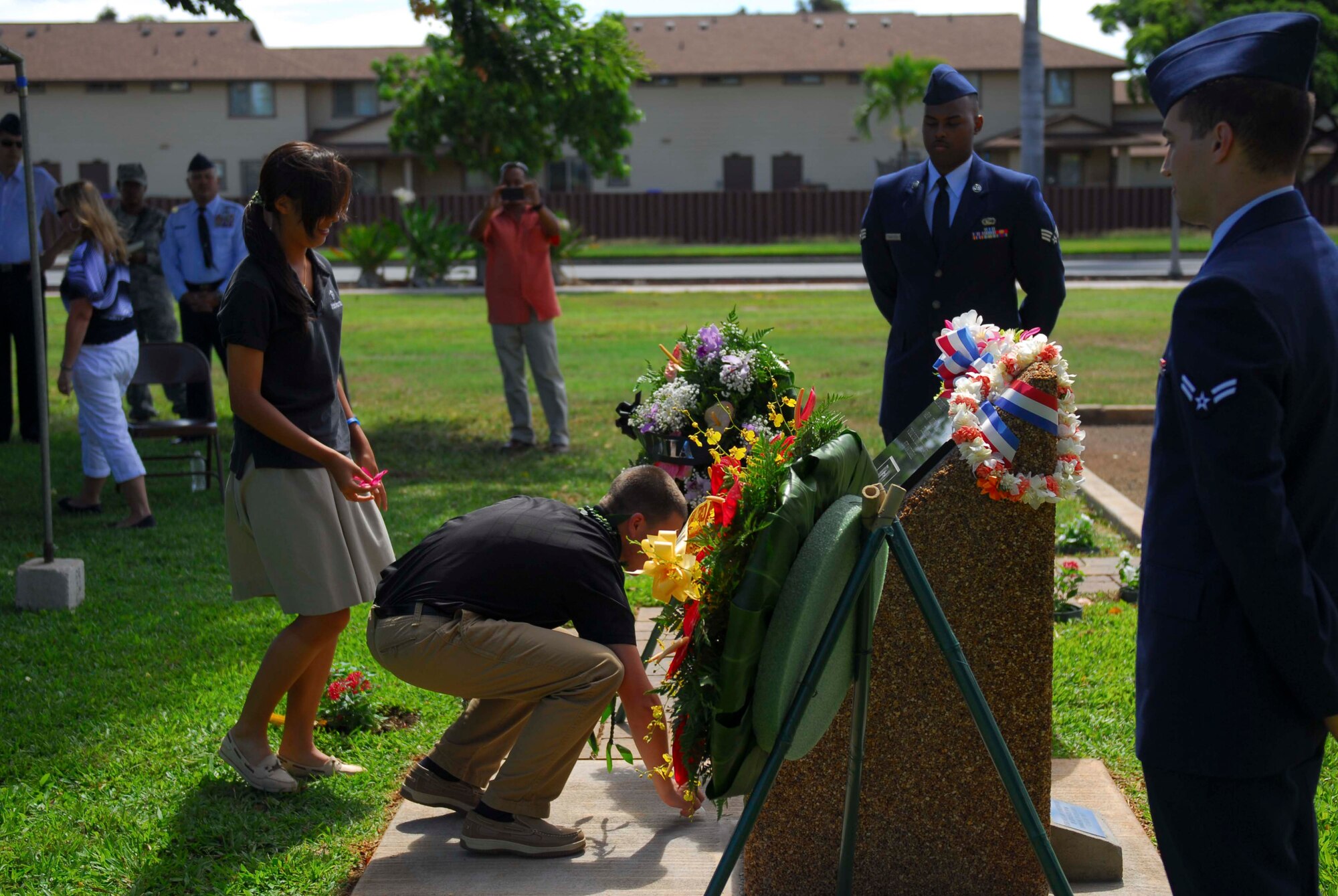 Bryan Ewing Jr, a junior at Hanalani High School, places a flower petal in front of the newly built Operation Homecoming memorial at the rededication ceremony at Joint Base Pearl Harbor-Hickam, Hawaii, on Oct. 7, 2013. In addition to partnering with the Hickam Chief’s Group and Top Three to make a financial donation, Ewing and his fellow classmates designed and constructed the new memorial as part of a community service project. (U.S. Air Force photo/Wiley Moore)