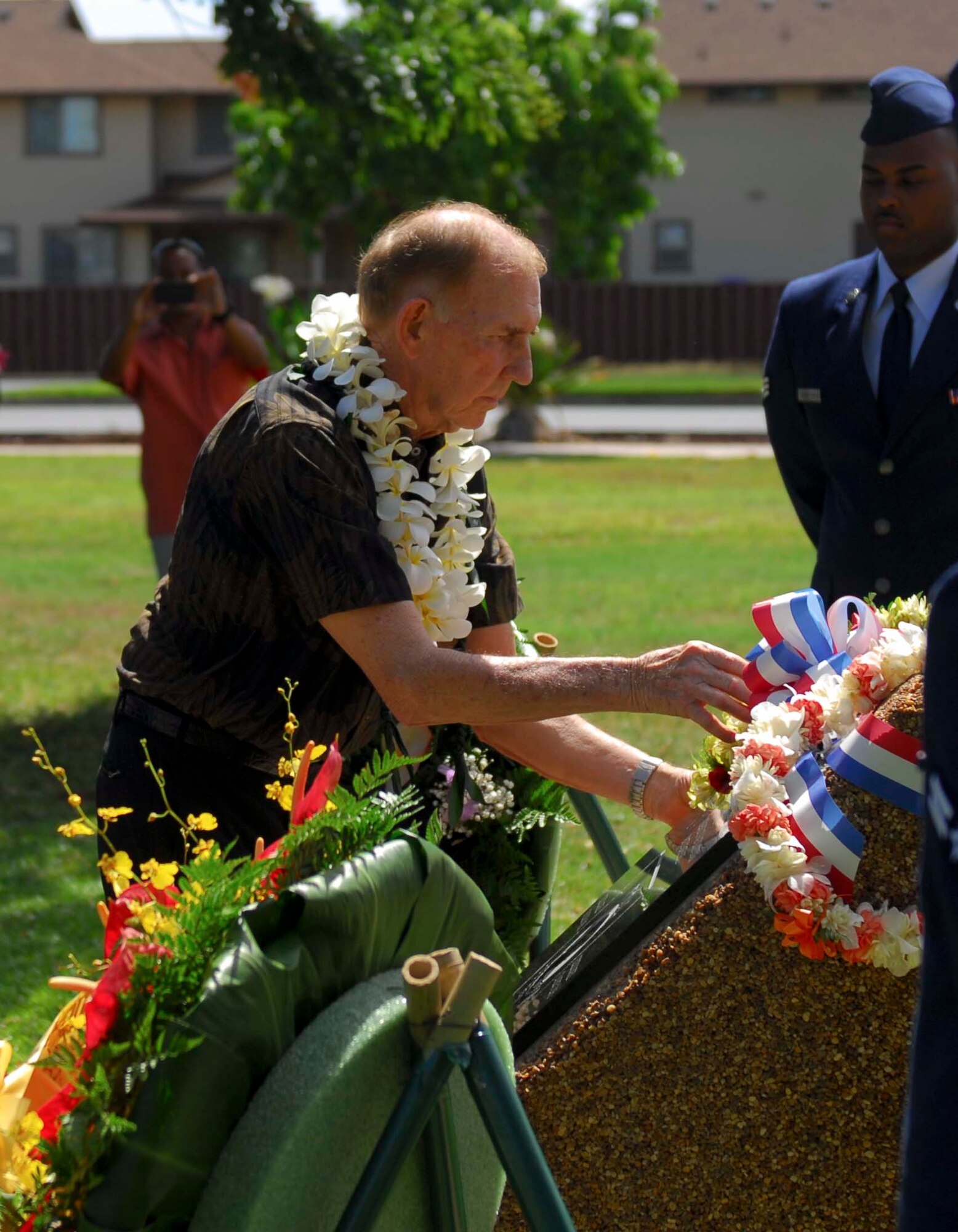 Retired Capt. Jerry Coffee, former Vietnam prisoner of war, places a lei on the new Operation Homecoming memorial at Joint Base Pearl Harbor-Hickam, Hawaii, on Oct. 7, 2013. Coffee, who was a POW for seven years and nine days, spoke about his time in prison and encouraged the ceremony’s attendees to never forget the contributions of the Vietnam veterans. (U.S. Air Force photo/Wiley Moore)