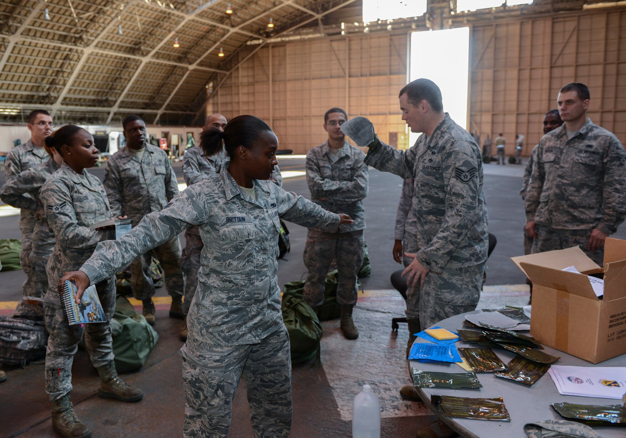 Staff Sgt. Timothy Lyons, 374th Civil Engineer Squadron, simulates patting down Airman 1st Class Brushunda Brittain, 374th Maintenance Squadron, with a M295 decontamination kit during the ability to survive and operate rodeo at Yokota Air Base, Japan, Oct. 8, 2013. The M295 can be used to decontaminate an individual or equipment. (U.S. Air Force photo by Senior Airman Michael Washburn/Released)