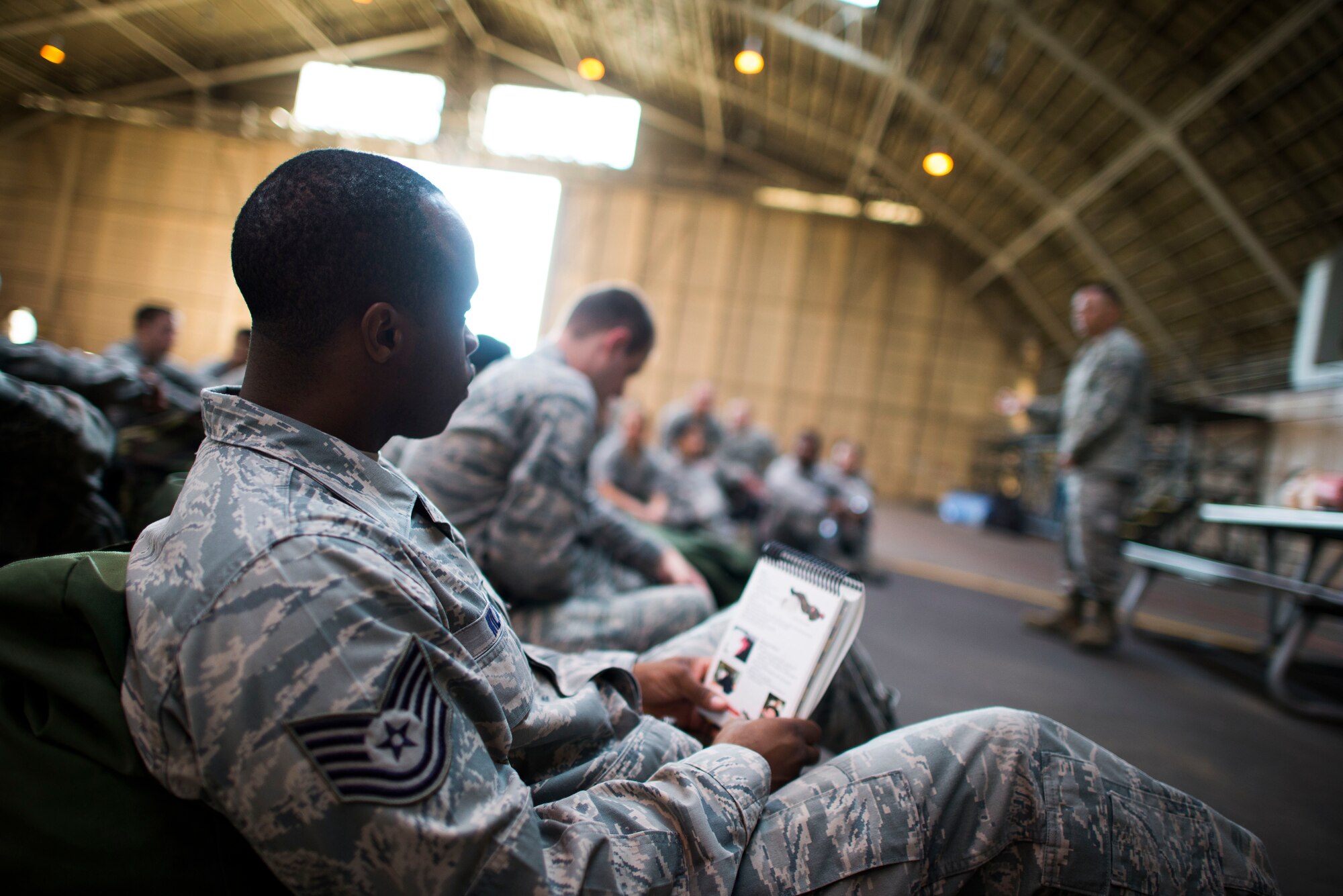 Tech Sgt. Derrick Wilcox, 374th Logistics Readiness Squadron, listens as an ability to survive and operate (ATSO) instructor explains the importance of Self Aid Buddy Care Oct. 9, 2013 at Yokota Air Base, Japan. Base-wide ATSO training was held to reacquaint Airmen with basic contingency skills. (U.S. Air Force photo by Staff Sgt. Chad C. Strohmeyer/Released)