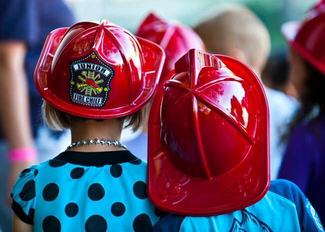 Children walk away after learning how to prevent kitchen fires and learning about a fire truck at the child development center Oct. 8, 2013, at Nellis Air Force Base, Nev, during Fire Prevention Week. According to the Center for Disease Control and Prevention, cooking is the primary cause of residential fires. (U.S. Air Force photo/Senior Airman Brett Clashman)