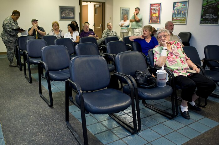 Service members, retirees and their family members wait to be seen at the identification card and Defense Enrollment Eligibility Reporting system office at the military personnel flight Oct. 4, 2013, at Nellis Air Force Base, Nev. The wait time during the low manning period is between two and three hours. (U.S. Air Force photo by Senior Airman Matthew Lancaster)