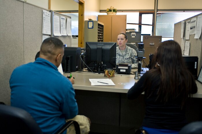 Tech. Sgt. Julie Duke, 799th Air Base Squadron customer service section chief, assist customers at the identification card and Defense Enrollment Eligibility Reporting system office at the military personnel flight Oct. 4, 2013, at Nellis Air Force Base, Nev. Due to the government shutdown, the contractors who work in the ID card and DEERS office were furloughed.  ID cards and DEERS enrollment will be held Monday, Wednesday and Friday from 7:30 a.m. to 3 p.m. One window will be open so customers can expect delays. (U.S. Air Force photo by Senior Airman Matthew Lancaster)