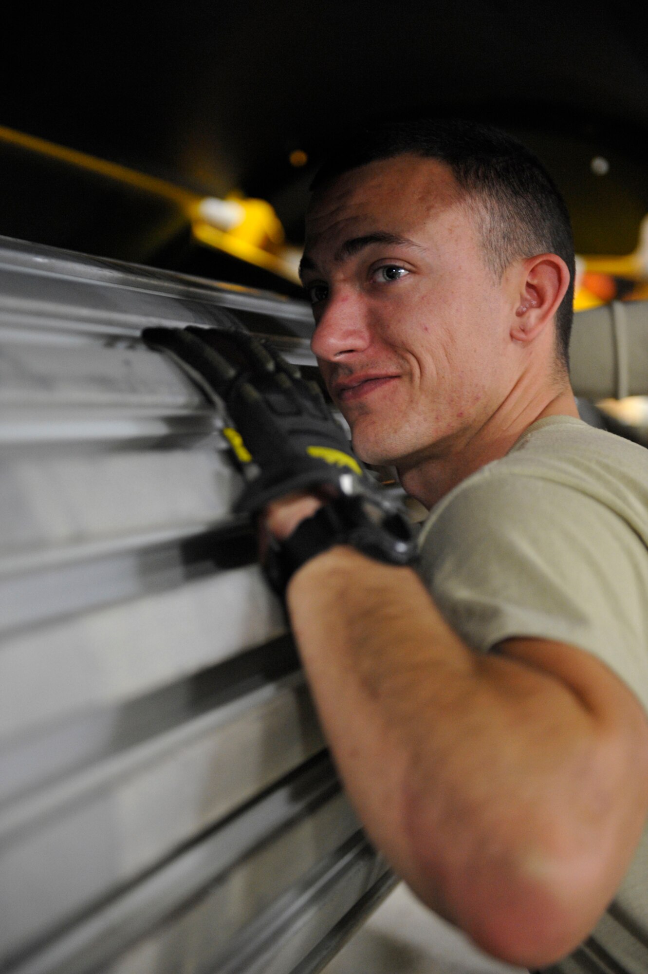 Senior Airmen Shane Crosby, 773rd Civil Engineer Squadron structural journeyman, checks the rails of an NB front mount broom for any foreign debris that could obstruct the mounting of heavy duty rotating bristles on Joint Base Elmendorf-Richardson, Oct. 4. Preparing for coming winter conditions, CE trains selected Airmen on heavy equipment operations to augment personnel in preparation of the coming winter months. (U.S. Air Force photo/Airman 1st Class Tammie Ramsouer)  