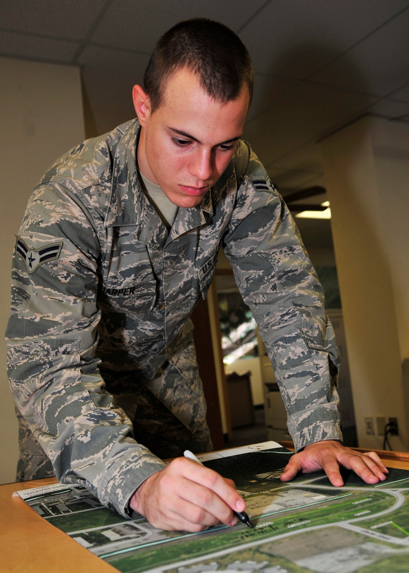Airman 1st Class William Harper, 354th Civil Engineer Squadron GeoBase flight engineering assistant, edits a map Oct. 3, 2013, Eielson Air Force Base, Alaska. One of GeoBase’s roles is to create maps when any type of spill occurs and when Airmen need to be briefed for situational awareness. (U.S. Air Force photo by Senior Airman Ashley Nicole Taylor/Released)