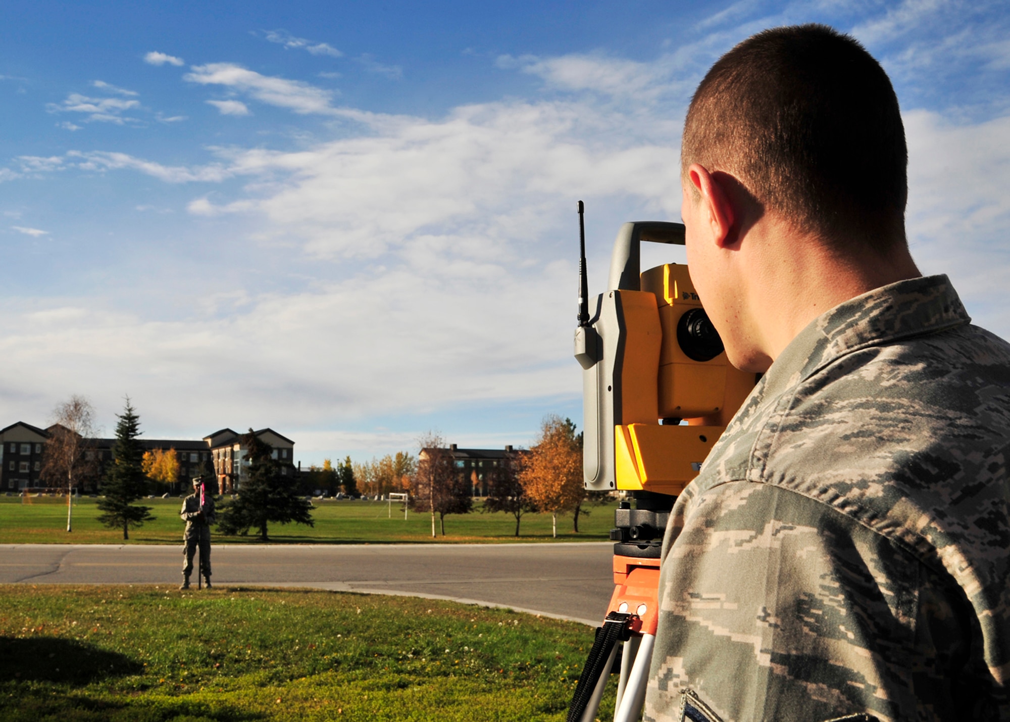Airmen 1st Class William Harper and Lakeye Scott, 354th Civil Engineer Squadron GeoBase flight engineering assistants, set up survey equipment Oct. 3, 2013, Eielson Air Force Base, Alaska. The survey equipment is used to collect vector data to update and create maps for projects around base. Contact the 354th CES/CEPT or stop by building 2258 to schedule an overview, brief or training. (U.S. Air Force photo by Senior Airman Ashley Nicole Taylor/Released)