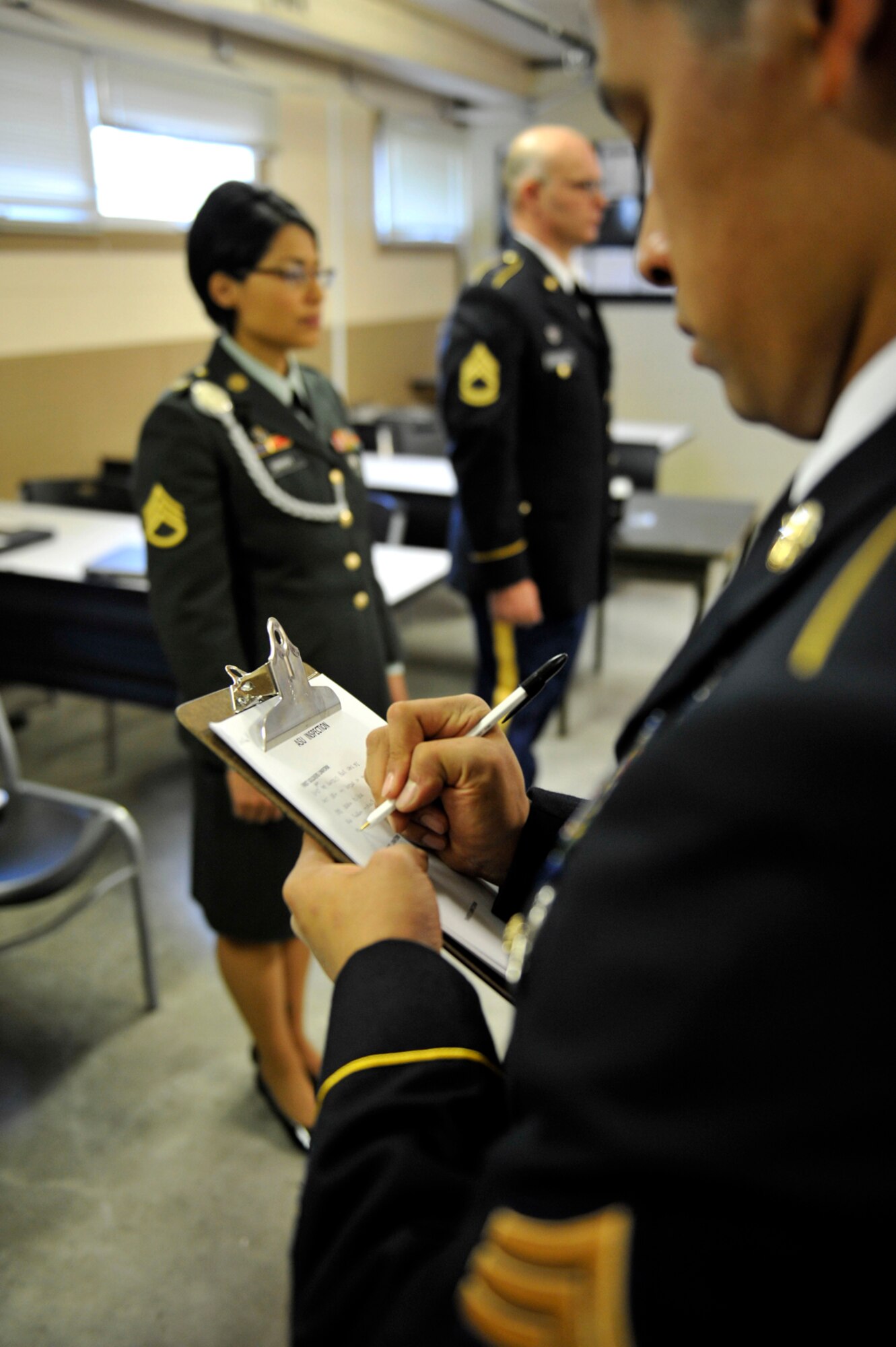 A U.S. Army Soldier prepares to inspect his peers, exhibiting his knowledge of dress and appearance regulations during the 2014 Alaskan National Guard Best Warrior Competition on Joint Base Elmendorf-Richardson, Sept. 28. The three-day competition included a variety of events testing Soldiers' supervisory, leadership and combat skills needed in today's military. (U.S. Air Force photo/Airman 1st Class Tammie Ramsouer)