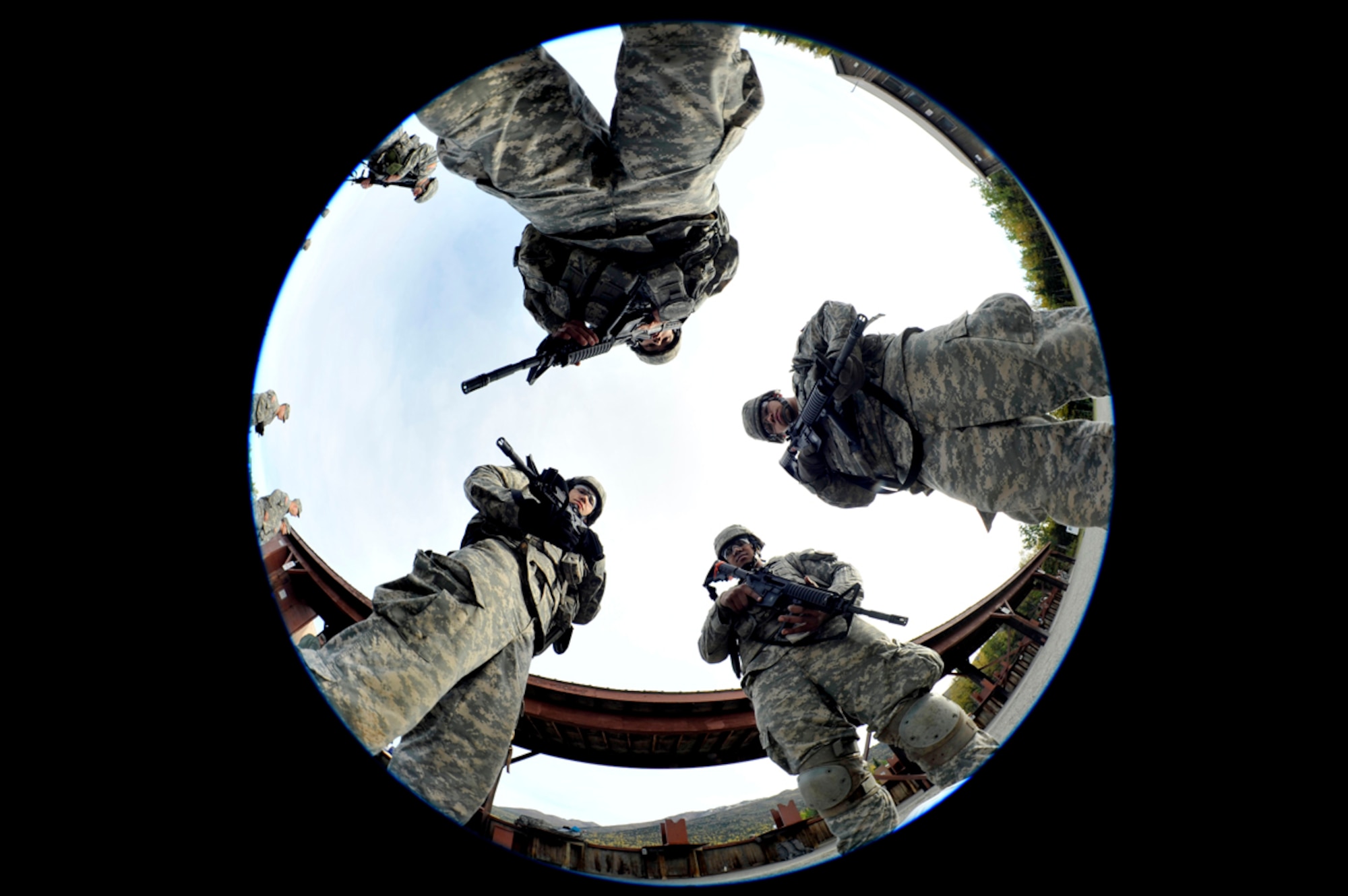 Participants from the 2014 Alaskan National Guard Best Warrior Competition circle around during a rest period on Joint Base Elmendorf-Richardson Sept. 28. The competition is hosted by the Army National Guard every year to pick the best of the best to represent the state at the Regional Best Warrior Competition. (U.S. Air Force photo/Airman 1st Class Tammie Ramsouer)