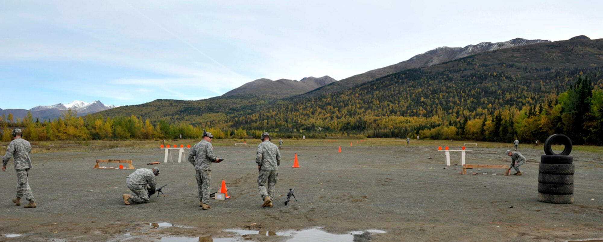 Cadres from the Alaska Army National Guard pick up targets during a weapons qualification event during the 2014 Alaskan National Guard Best Warrior Competition on Joint Base Elmendorf-Richardson, Sept. 28. They challenged the competitors with mental and physical tests in a three-day event including multiple weapons shooting. (U.S. Air Force photo/Airman 1st Class Tammie Ramsouer)