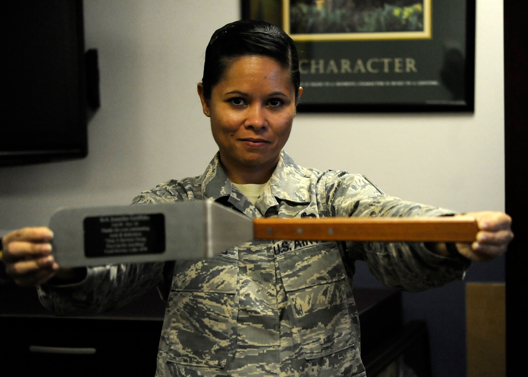 Master Sgt. Jennifer Griffiths, Hurlburt Field Airman Leadership School
commandant, holds a spatula in her office at Hurlburt Field, Fla., Oct. 8,
2013. It was given to her as a going away gift when she was a senior airman
in services. (U.S. Air Force photo/Staff Sgt. Jeff Andrejcik)
