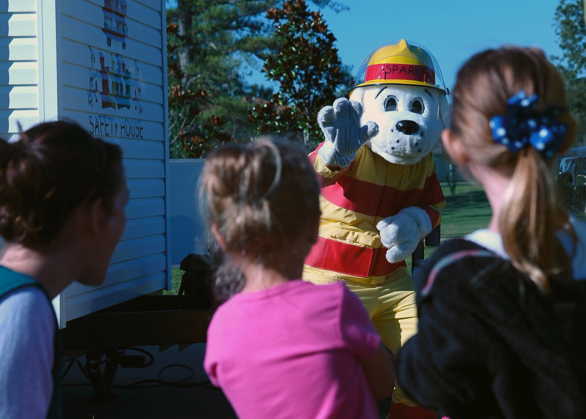 Sparky waves to a group of children outside of the Child Development Center Oct. 8 as part of Fire Prevention Week. Sparky visited many areas on Columbus Air Force Base during the week to include the Fire Station, the CDC and the Youth Center. (U.S. Air Force Photo/Airman Lile)