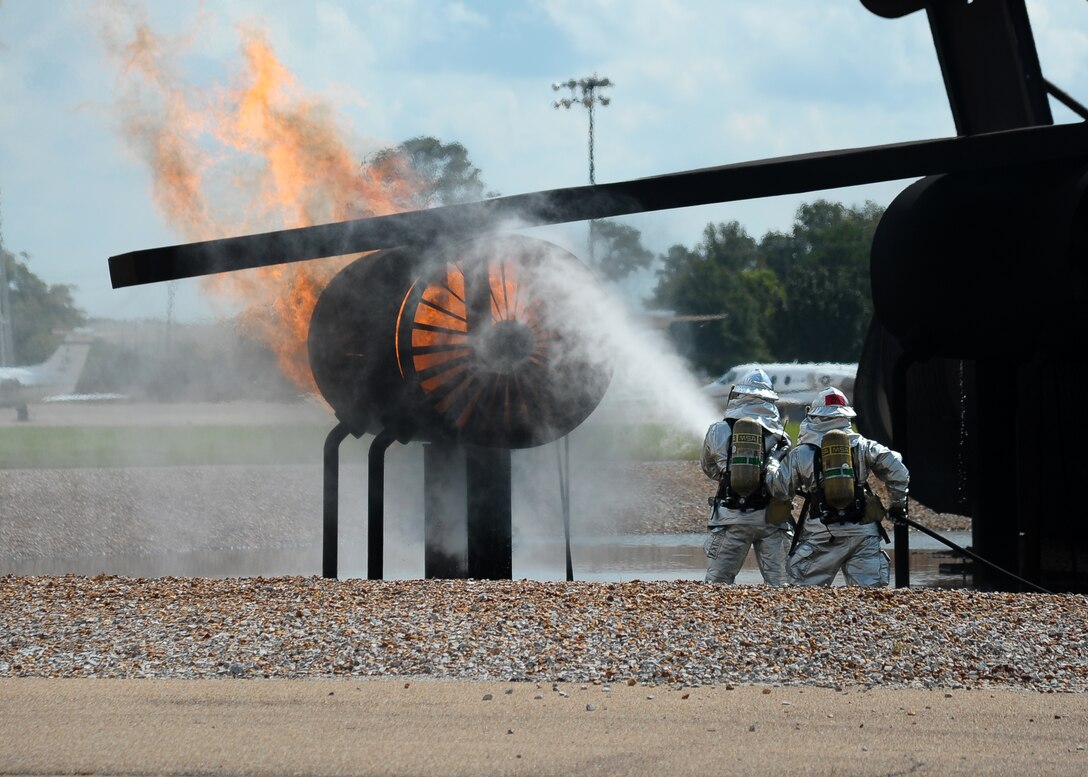 Firefighters from the 14th Civil Engineer Squadron demonstrate for a crowd how quickly and efficiently they can put out a jet engine fire at a live burn Oct. 5 as part of the Fire Prevention Week kick-off. (U.S. Air Force Photo/Airman 1st Class Stephanie Englar)