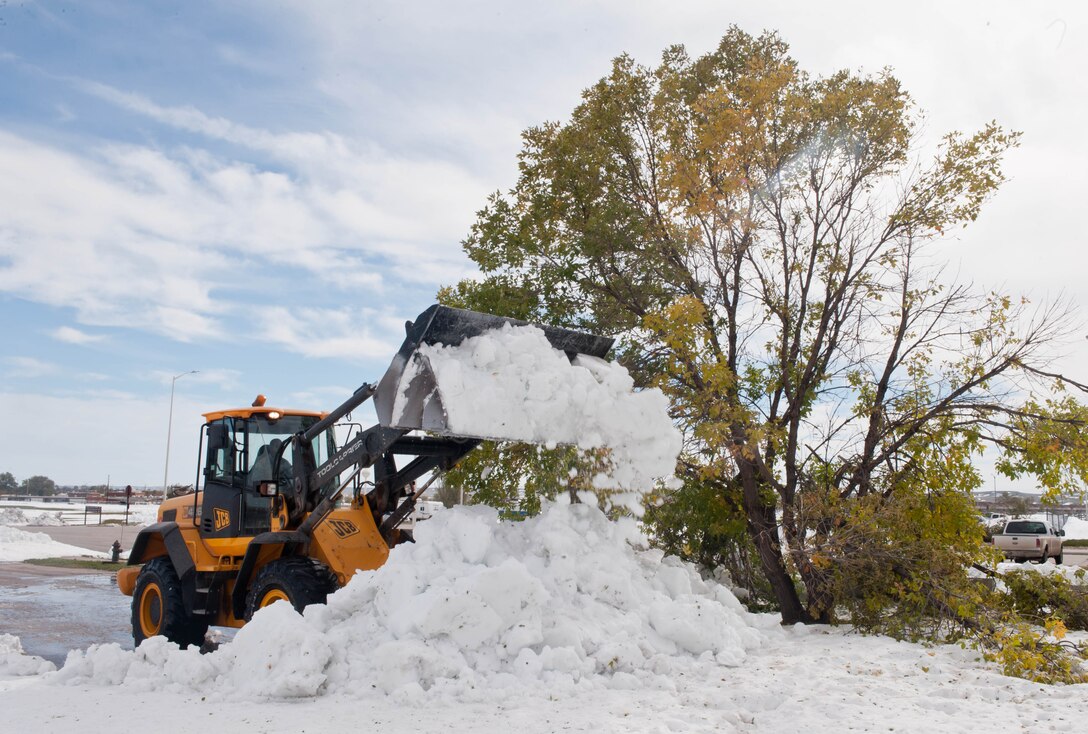 Airmen assigned to the 28th Civil Engineer Squadron clear the streets of snow at Ellsworth Air Force Base, S.D., Oct. 8, 2013 to return the road condition to green. Pavement and construction equipment specialists operate and maintain heavy construction equipment such as front-end loaders, bulldozers, dump trucks, skid steer loaders and road graders to keep operations running at Ellsworth. (U.S. Air Force photo by Senior Airman Zachary Hada/Released)