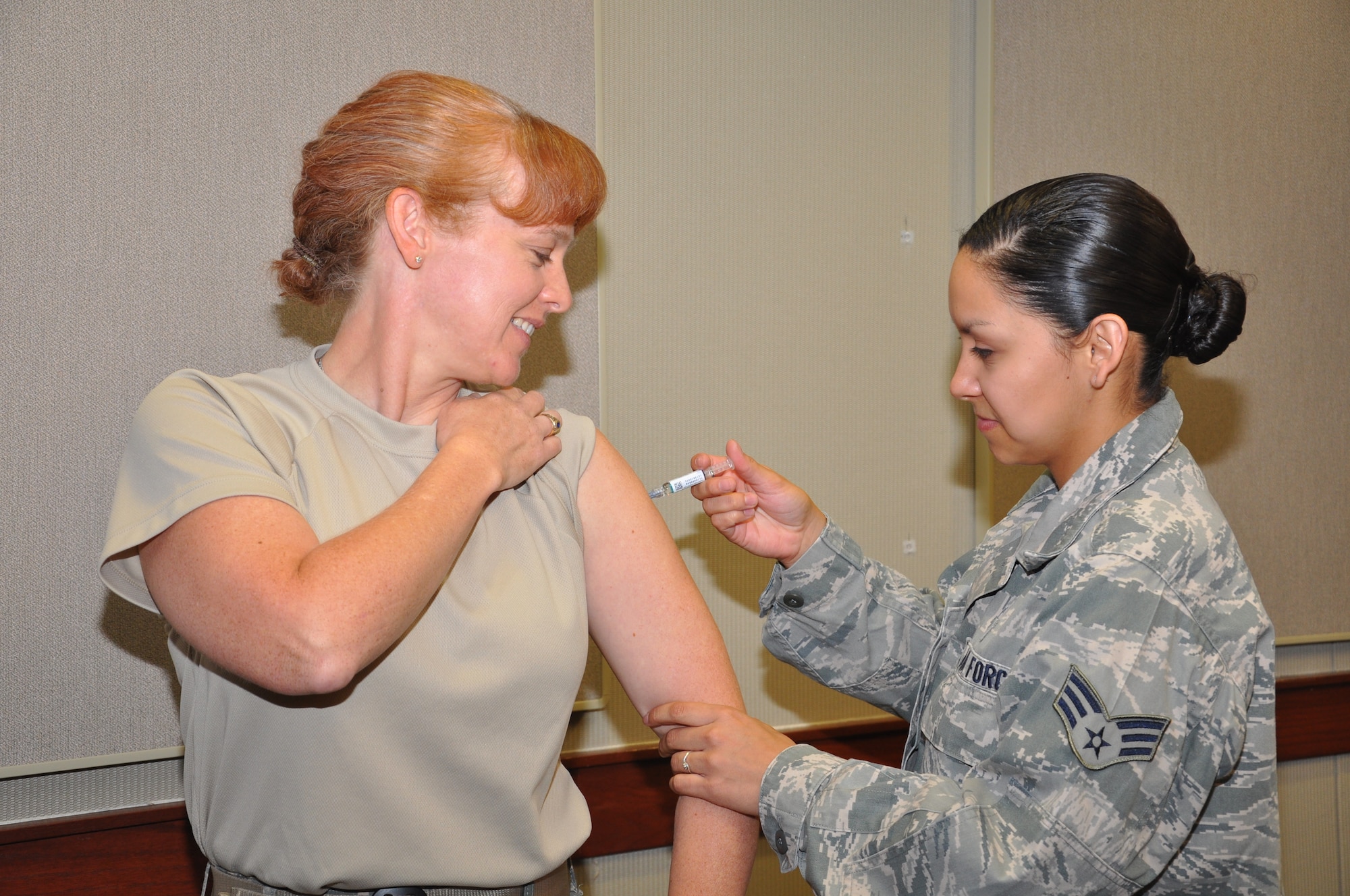 GOODFELLOW AIR FORCE BASE, TEXAS- Col. Kimberlee Joos, 17th Training Wing Commander, receives her annual flu shot from Senior Airman Carlee Garza, 17th Medical Group, at the Norma Brown Building Oct. 8. All active duty military members are required to receive the shot annually. (U.S. Air Force photo/ Airman 1st Class Erica Rodriguez)