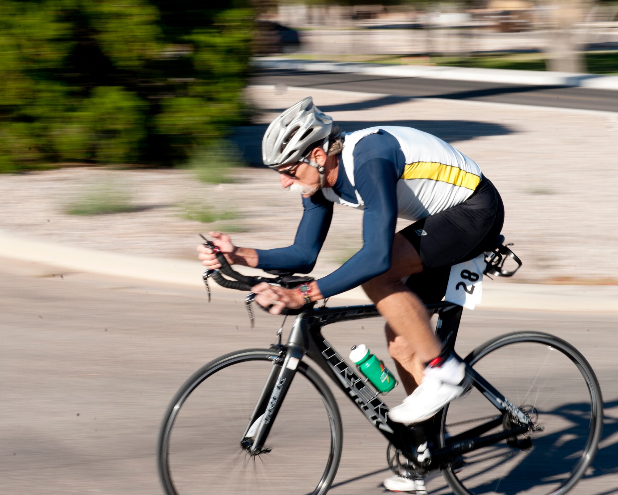 A member of Team Holloman begins the 30K biking portion of the annual Triathlon at Holloman Air Force Base, N.M., Oct. 5. The athletes took part in a 5k run, 30k bike and a 700 meter swim to complete the race. (U.S. Air Force photo by Airman 1st Class Daniel E. Liddicoet/Released)