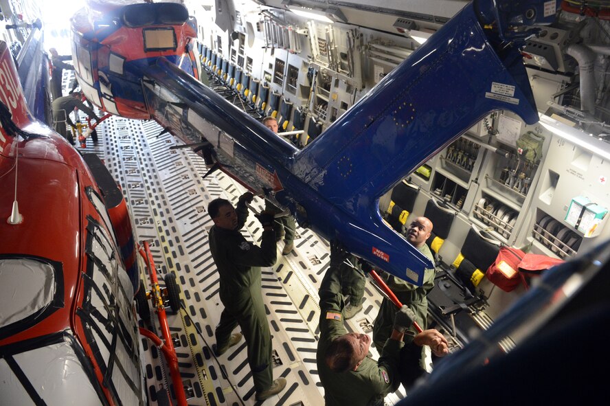 Loadmasters from the 62nd and 446th Airlift Wings position a Bell 212 Twin Huey helicopter in a C-17 Globemaster III aircraft, Oct. 5, 2013, at Joint Base Lewis-McChord, Wash. The Airmen loaded a total four helicopters onto the aircraft in preperation for their deployment to Christchurch, New Zealand, in support of Operation Deep Freeze. (U.S. Air Force Photo/Airman 1st Class Jacob Jimenez)