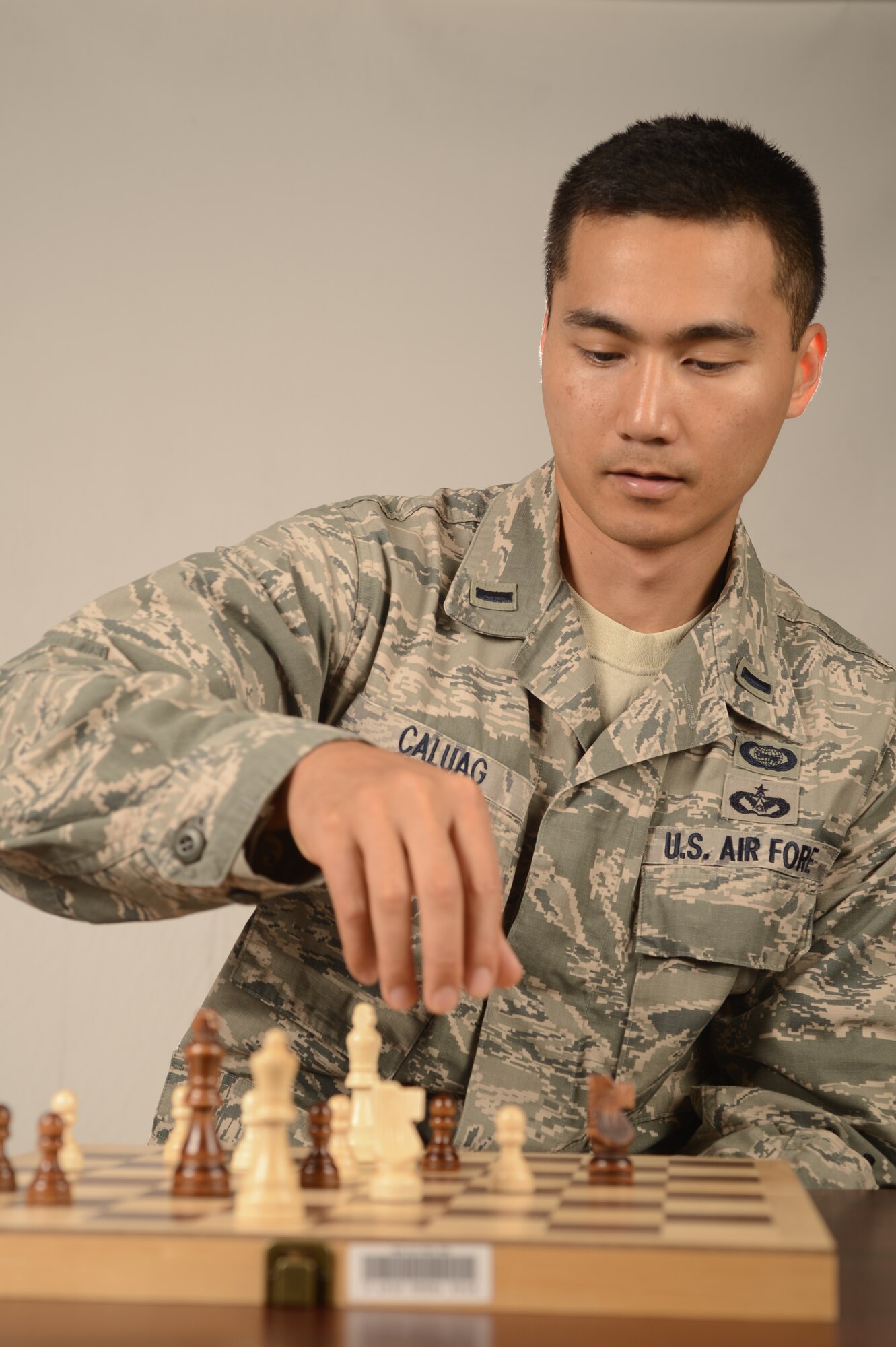 U.S. Air Force 1st Lt. Martin Caluag, 77th Fighter Squadron chief of intelligence, plays a game of chess at Shaw Air Force Base, S.C., Sept. 13, 2013. In his free time, Caluag teaches chess and math. (U.S. Air Force photo by Airman 1st Class Krystal M. Jeffers/Released)