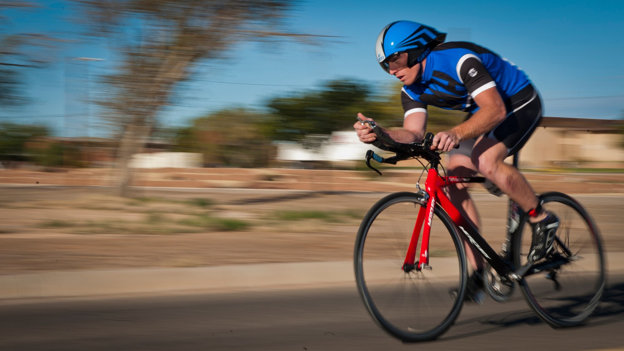 A member of Team Holloman begins the 30K biking portion of the annual Triathlon at Holloman Air Force Base, N.M., Oct. 5. The athletes took part in a 5k run, 30k bike and a 700 meter swim to complete the race. (U.S. Air Force photo by Airman 1st Class Aaron Montoya/Released)