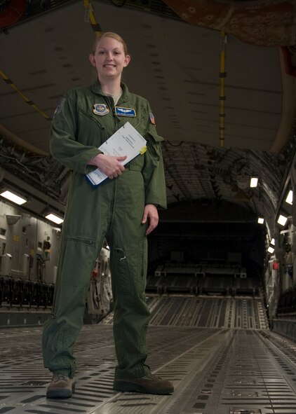 Senior Airman Valerie Stephens, 3rd Airlift Squadron loadmaster instructor, stands inside a C-17 Globemaster III while holding the abbreviated flight crew checklist for loadmasters Oct. 8, 2013, at Dover Air Force Base, Del. Stephens is Airman of the month  for the 436th Operations Support Squadron and currently works as a scheduler. She recently returned from loadmaster instructor school in Altus Air Force Base, Okla. (U.S. Air Force photo/Senior Airman Jared Duhon)