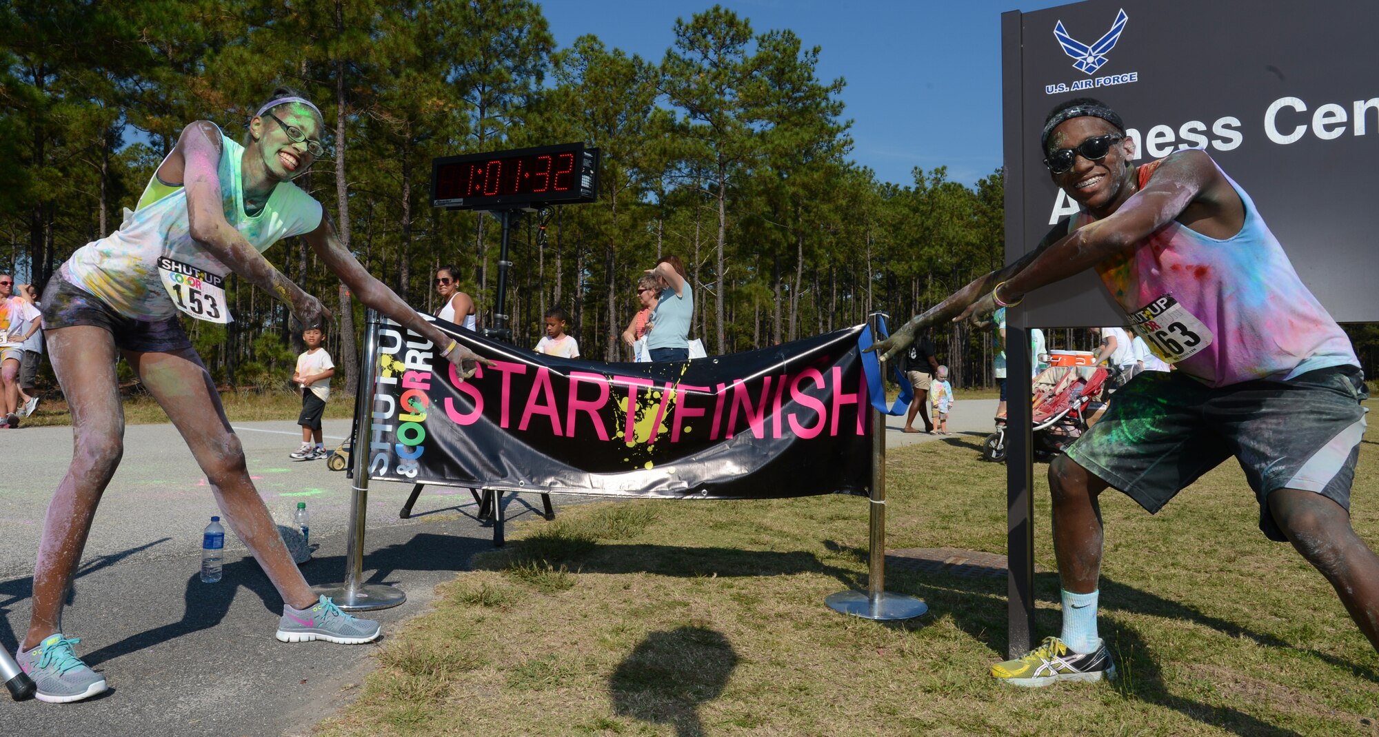 Participants of the Shut Up and Color Run 5K point out the start and finish line for the race, Shaw Air Force Base, S.C., Oct. 5, 2013. About 500 people came out for the Shut Up and Color Run, where participants were doused with six different colors by the end of the 5K run. (U.S. Air Force photo by Senior Airman Tabatha Zarrella/Released)
