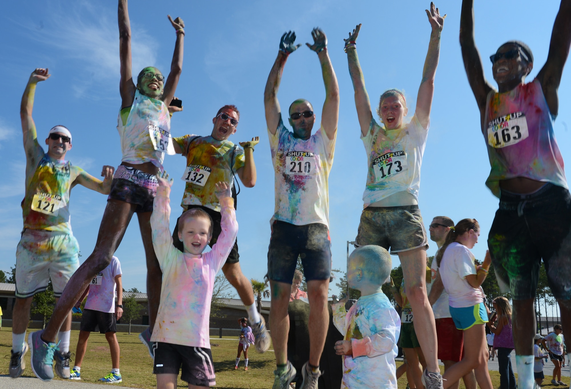 Participants of the Shut Up and Color Run 5K cheer in celebration for finishing the race at Shaw Air Force Base, S.C., Oct. 5, 2013. The 20th Force Support Squadron held Shaw's first Shut Up and Color Run, in which the participants were doused in colored powder. (U.S. Air Force photo by Senior Airman Tabatha Zarrella/Released)
