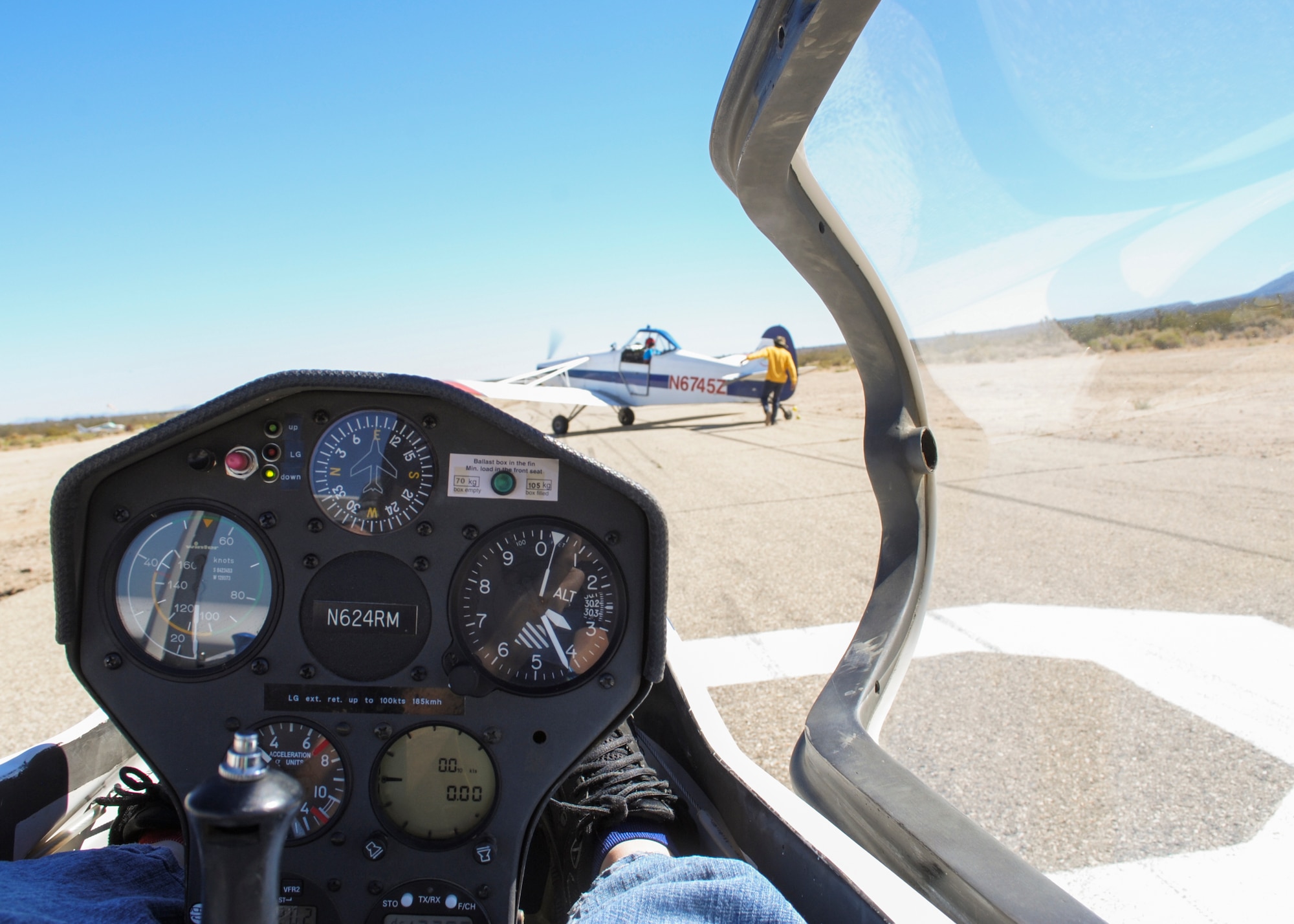 Southern California Soaring Academy employees prepare for a customer flight by connecting the tow plane to the glider. (U.S. Air Force photo by Rebecca Amber) 