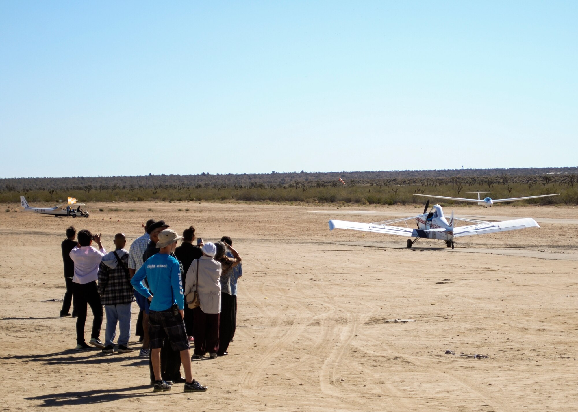 Spectators watch as a glider plane comes in for a landing after a Sunday morning ride at Crystal Airport, which is a private-use airport located six miles south of Pearblossom, California. (U.S. Air Force photo by Rebecca Amber) 